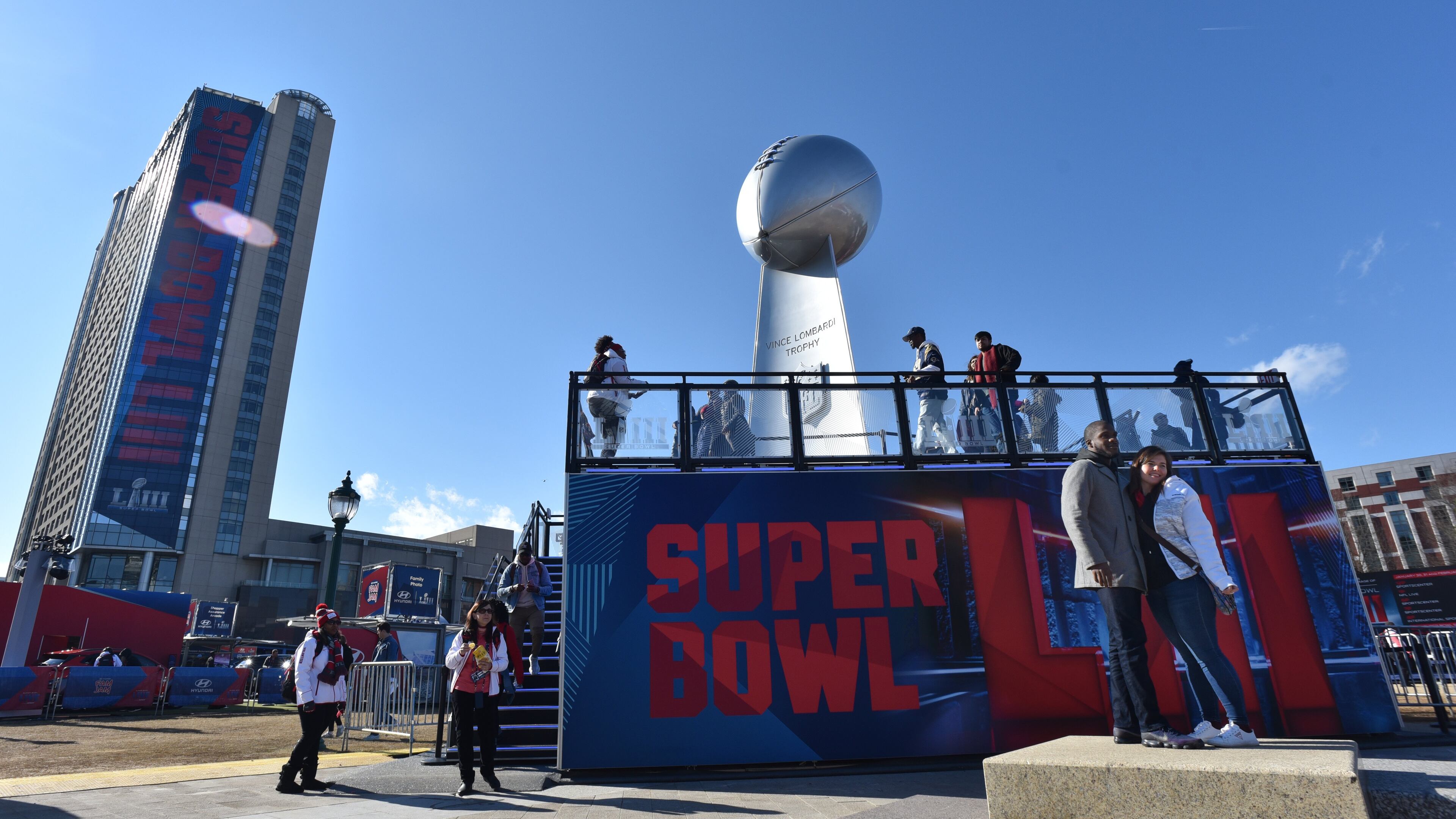 A super-sized version of the Lombardi Trophy attracts many visitors at Super Bowl Live, a fan village featuring concerts and other attractions, in Centennial Olympic Park. HYOSUB SHIN / HSHIN@AJC.COM