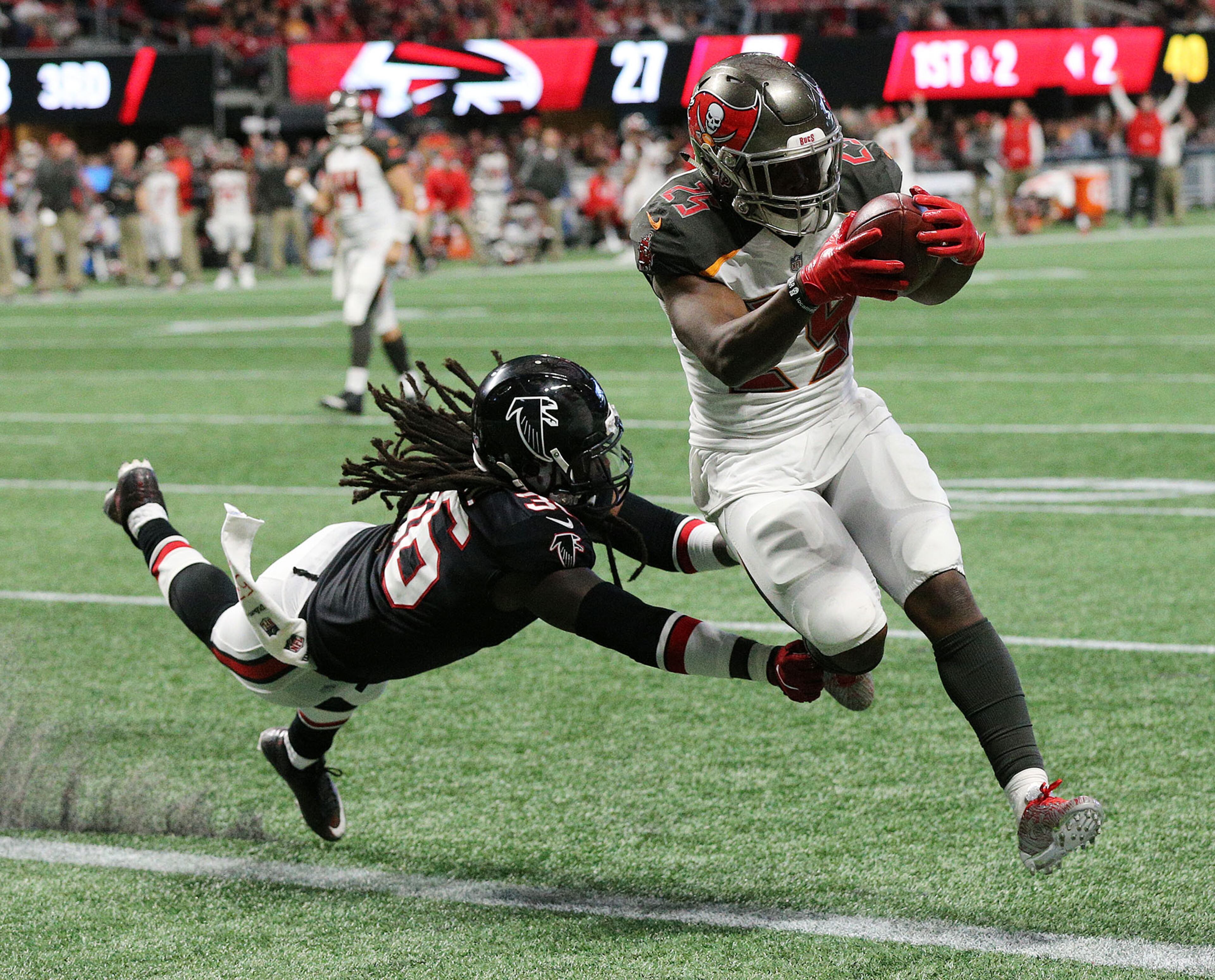 November 26, 2017 Atlanta: Buccaneers running back Peyton Barber gets past Falcons safety Kemal Ishmael for a touchdown during the third quarter in a NFL football game on Sunday, November 26, 2017, in Atlanta. Curtis Compton/ccompton@ajc.com
