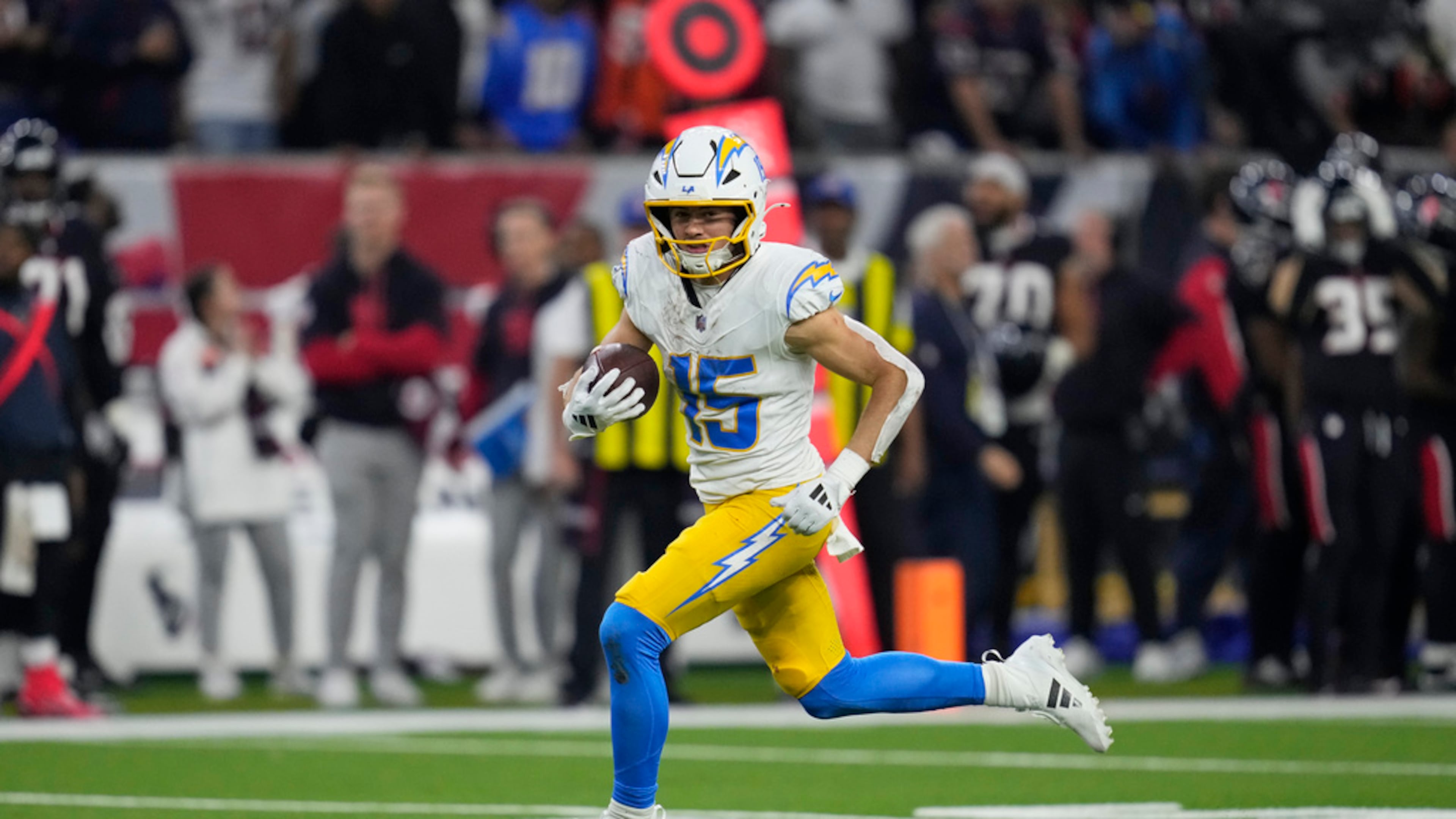 Los Angeles Chargers wide receiver Ladd McConkey runs toward the end zone after catching a pass to score a touchdown against the Houston Texans during the second half of an NFL wild-card playoff football game Saturday, Jan. 11, 2025, in Houston. (AP Photo/Ashely Landis)