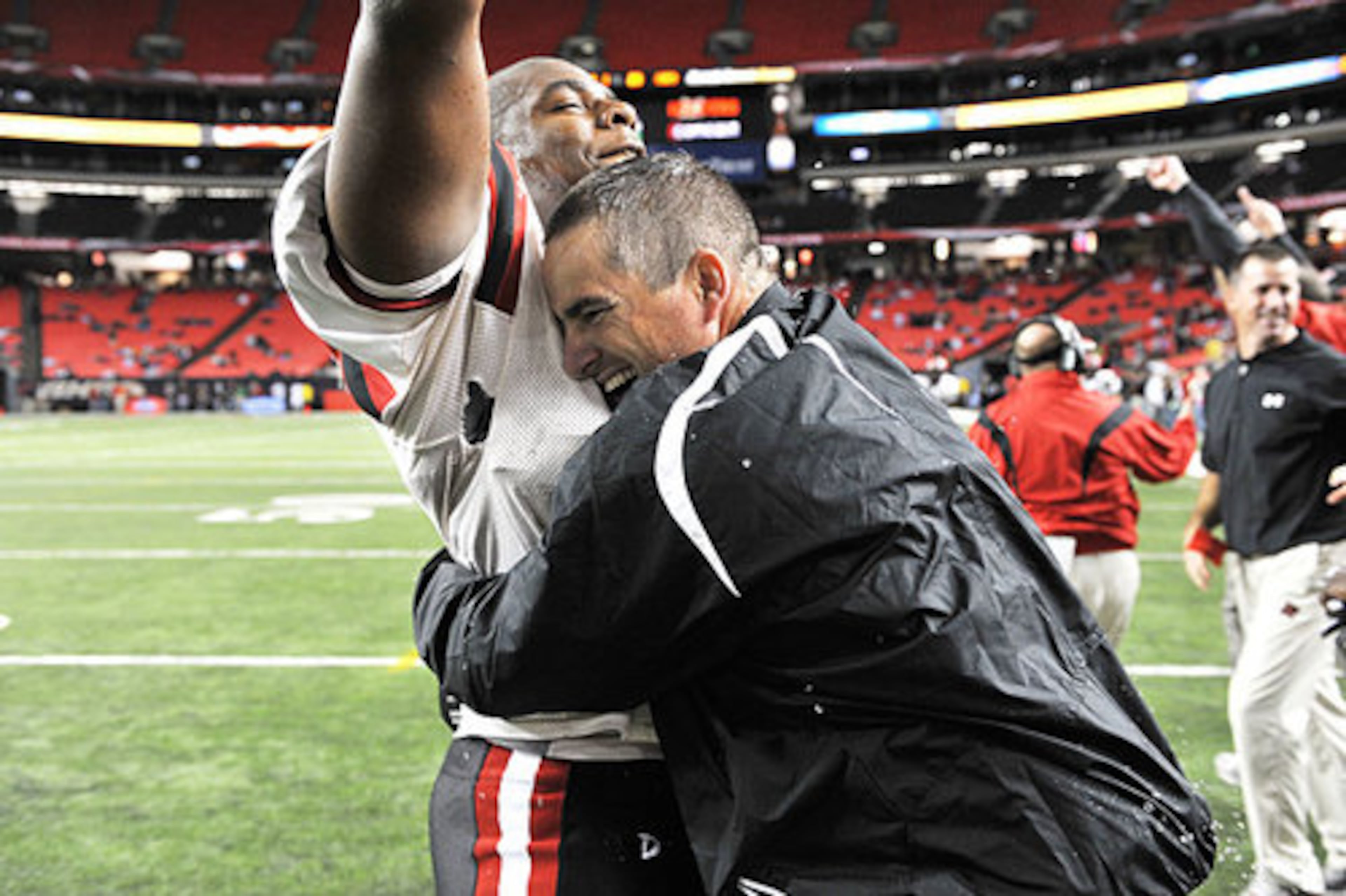 Hug-worthy. Cairo head coach Tom Fallaw celebrates the Syrupmakers' victory over Flowery Branch with Montavious Williams.
