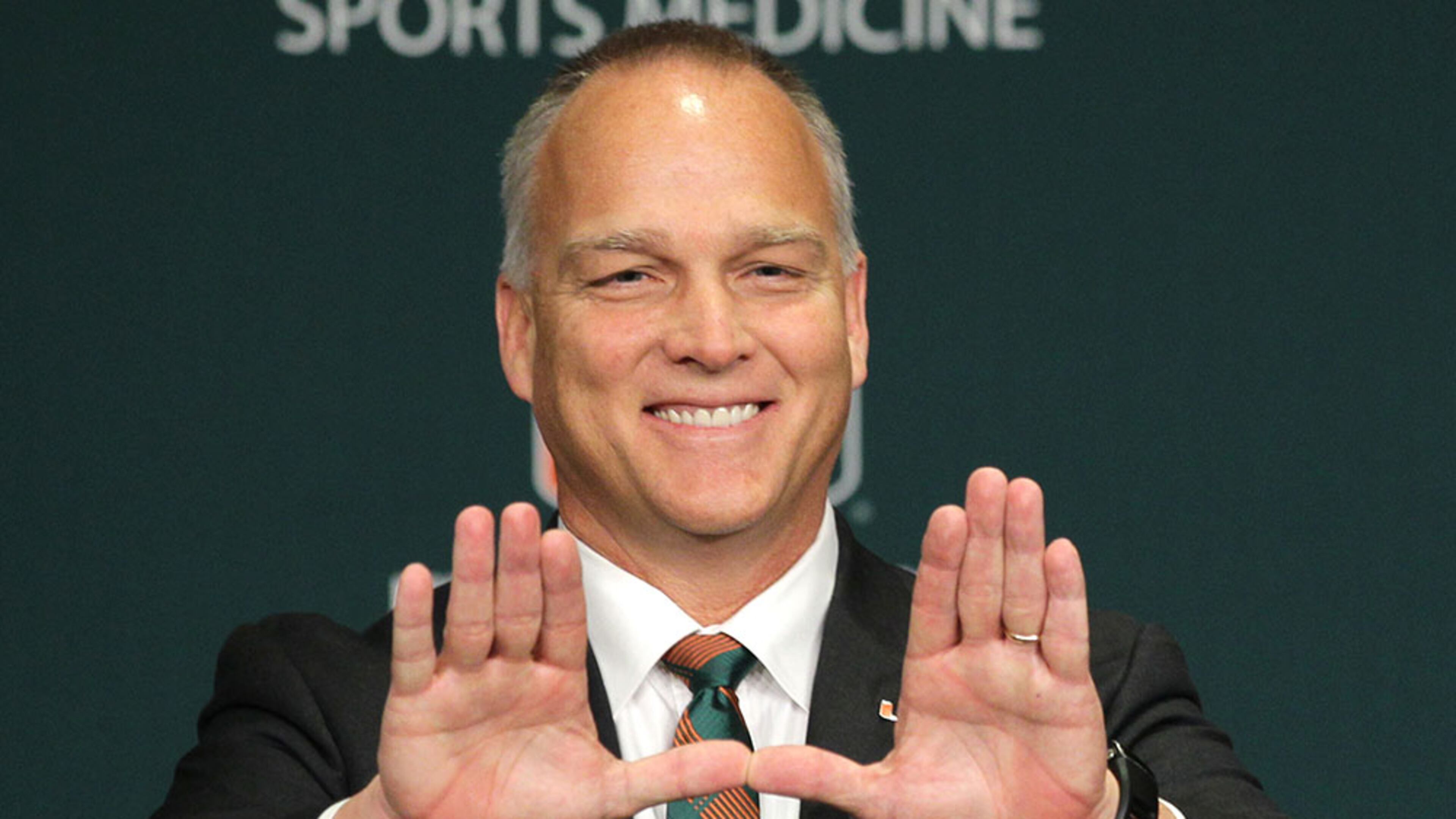 Mark Richt makes "The U" symbol after being introduced as the new head coach at the University of Miami, Friday, Dec. 4, 2015 in Coral Gables, Fla.