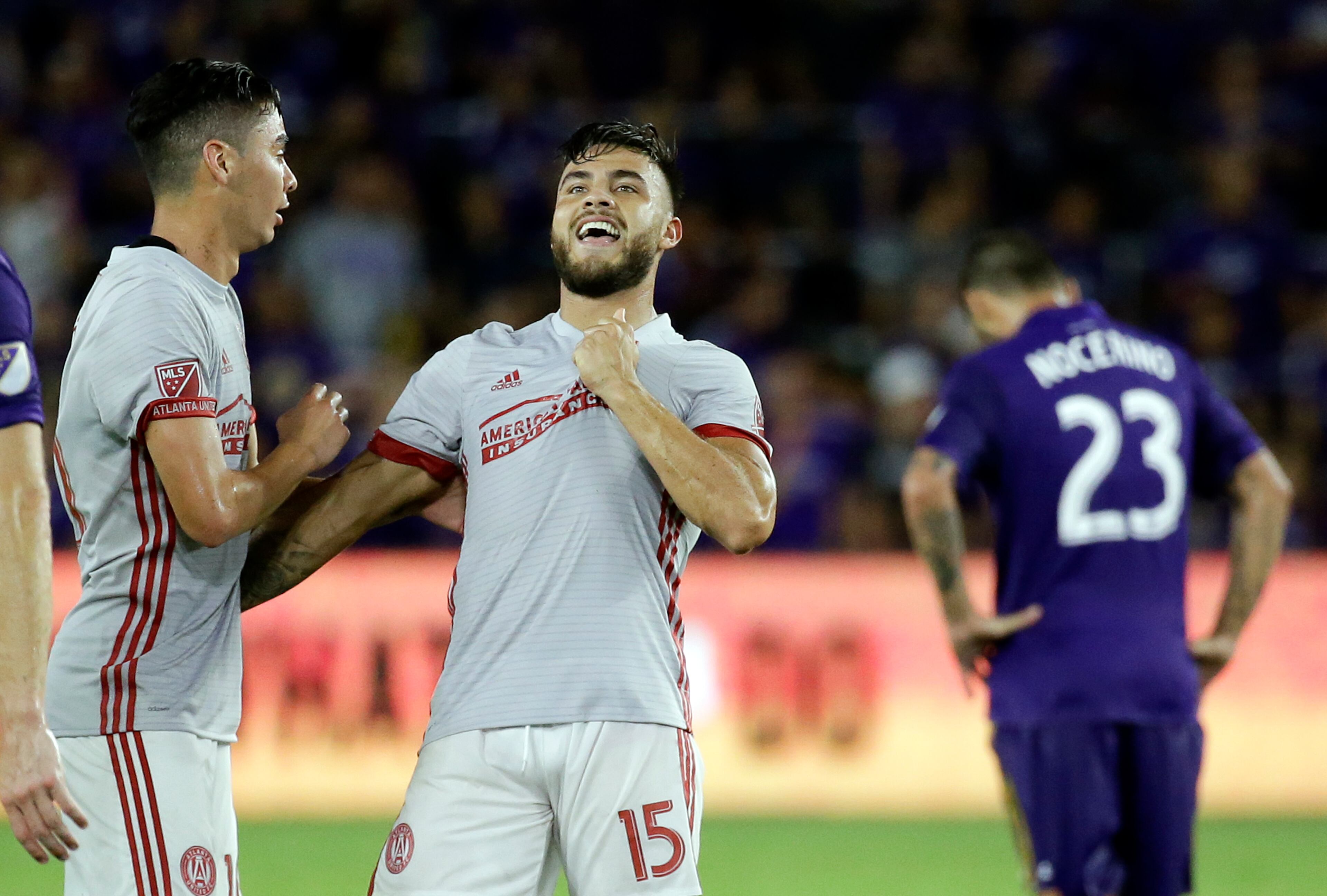 Atlanta United's Hector Villalba (15) celebrates his goal with teammate Miguel Almiron, left, as Orlando City's Antonio Nocerino (23) walks away during the second half of an MLS soccer match, Friday, July 21, 2017, in Orlando, Fla. Atlanta United won 1-0. (AP Photo/John Raoux)