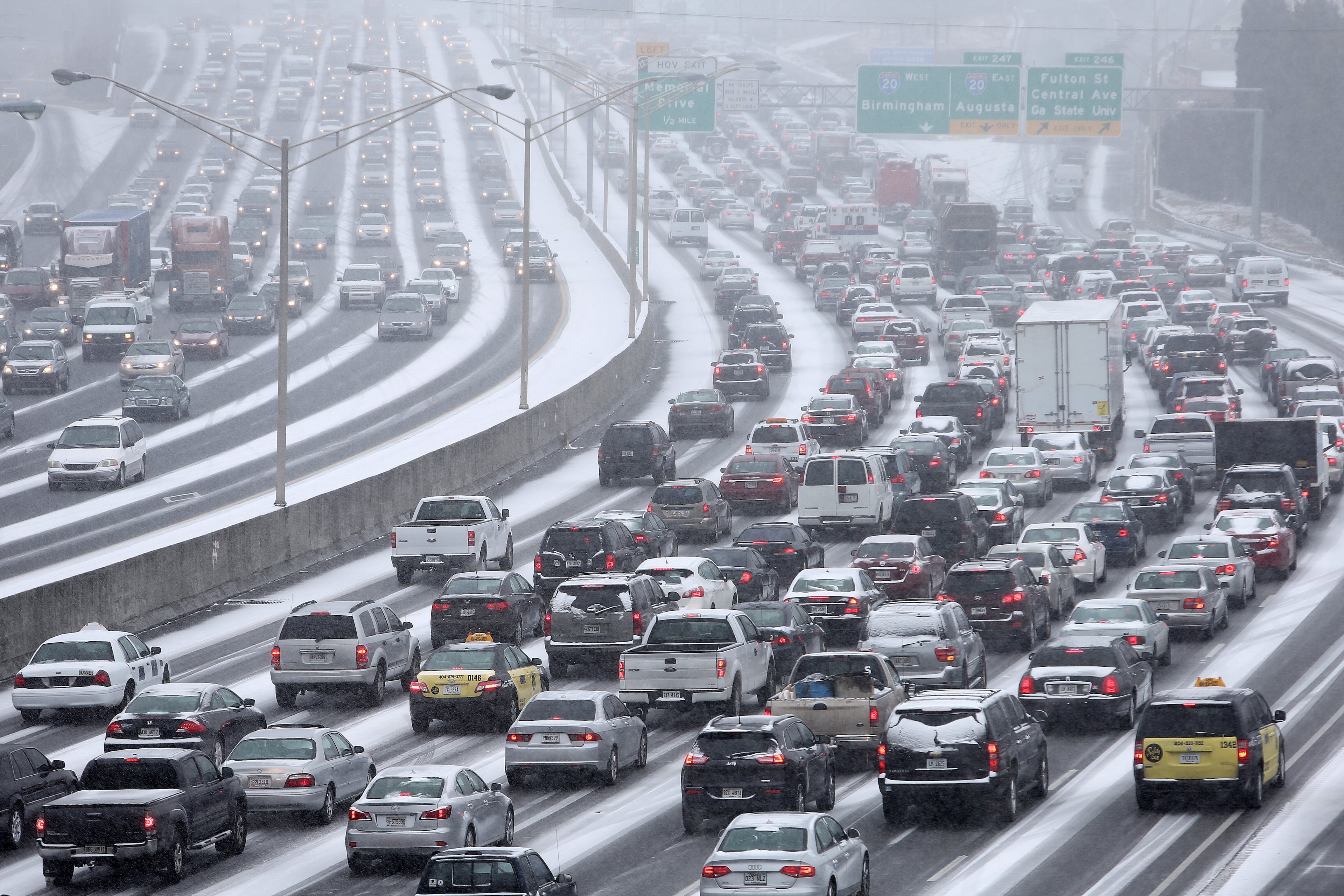 Atlanta: Traffic inches along the Connector as snow blankets the Metro on Tuesday afternoon January 28, 2014 as seen from the Pryor Street overpass. BEN GRAY / BGRAY@AJC.COM