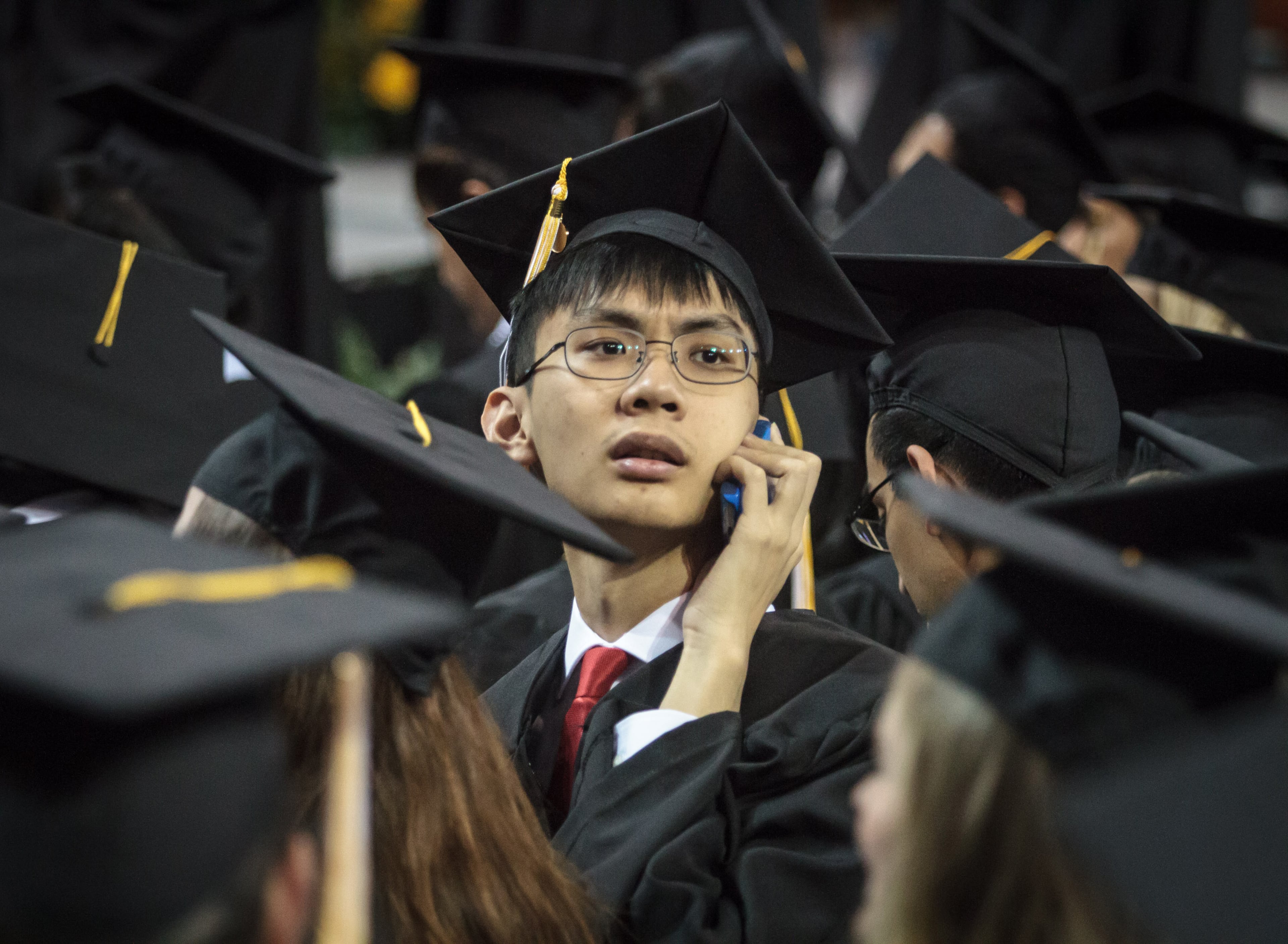 Students look for friends and family before the start of the Georgia Institute of Technology's morning graduation ceremony at McCamish Pavilion, May. 6 2017. 2,400 students graduated during the two ceremonies Saturday. STEVE SCHAEFER / SPECIAL TO THE AJC