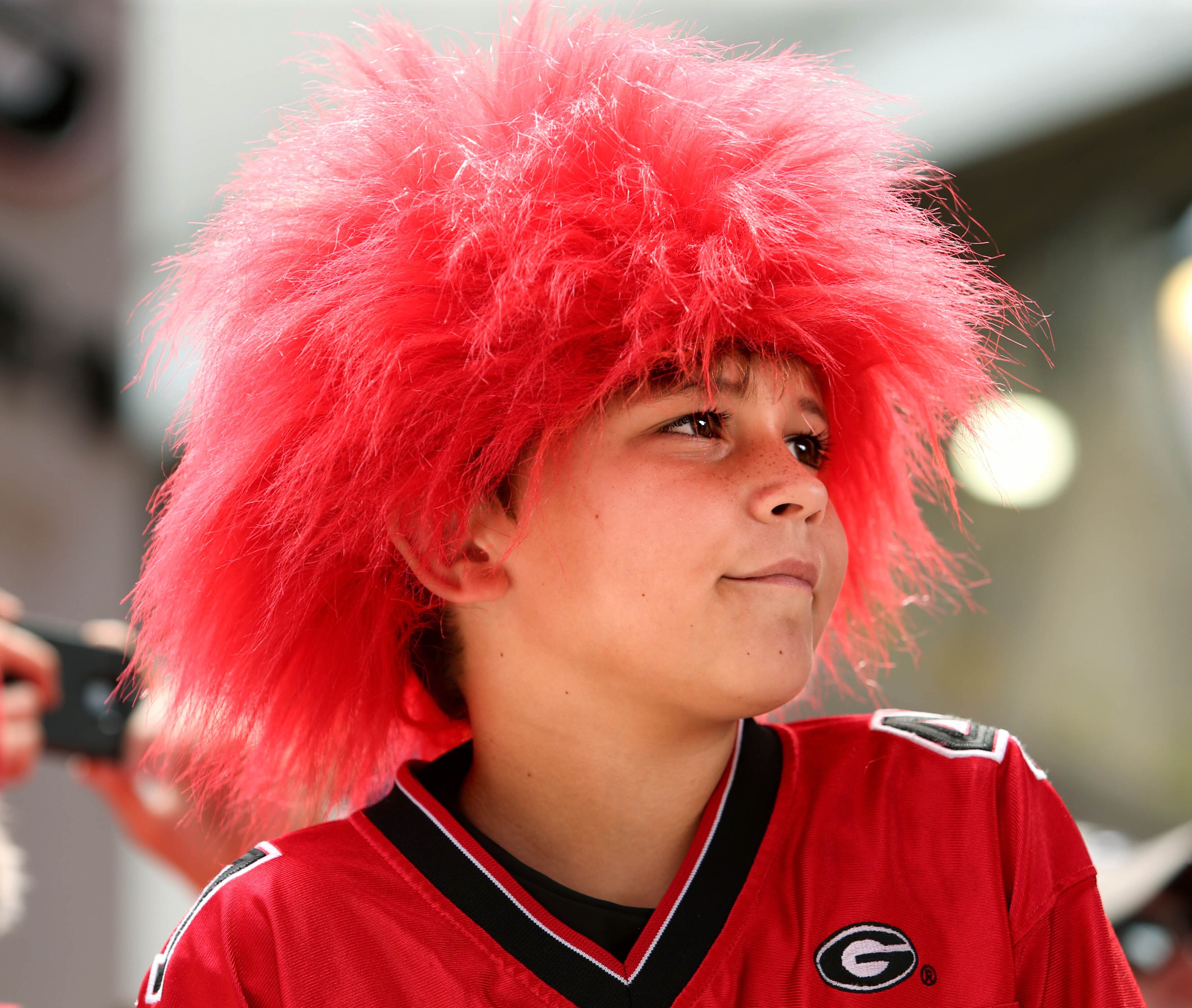University of Georgia fan Ethan Bond, 9, wears a red wig as he waits for the Dawg Walk before Georgia's game against Louisiana State University at Sanford Stadium Saturday afternoon in Athens, Ga., September 28, 2013. Earlier in the week Coach Mark Richt asked fans to wear red for a "Red Out," during their game against LSU.