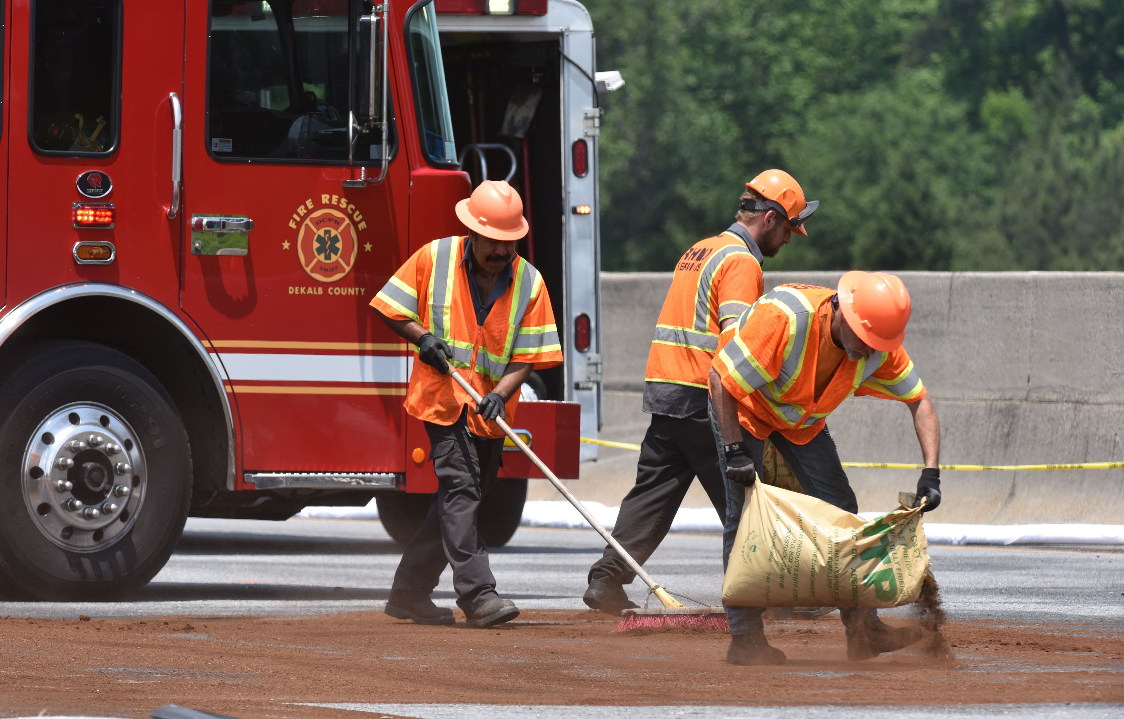 May 8, 2015 Atlanta - Cleaning crew members apply oil absorbent on I-285 at Peachtree Industrial Boulevard, where four people died aboard a small plan on Friday, May 8, 2015. Traffic was shut down in both directions. Three men and one woman were killed in the crash, according to Channel 2 Action News. The National Transportation Safety Board is in charge of the investigation and will determine probable cause. HYOSUB SHIN / HSHIN@AJC.COM