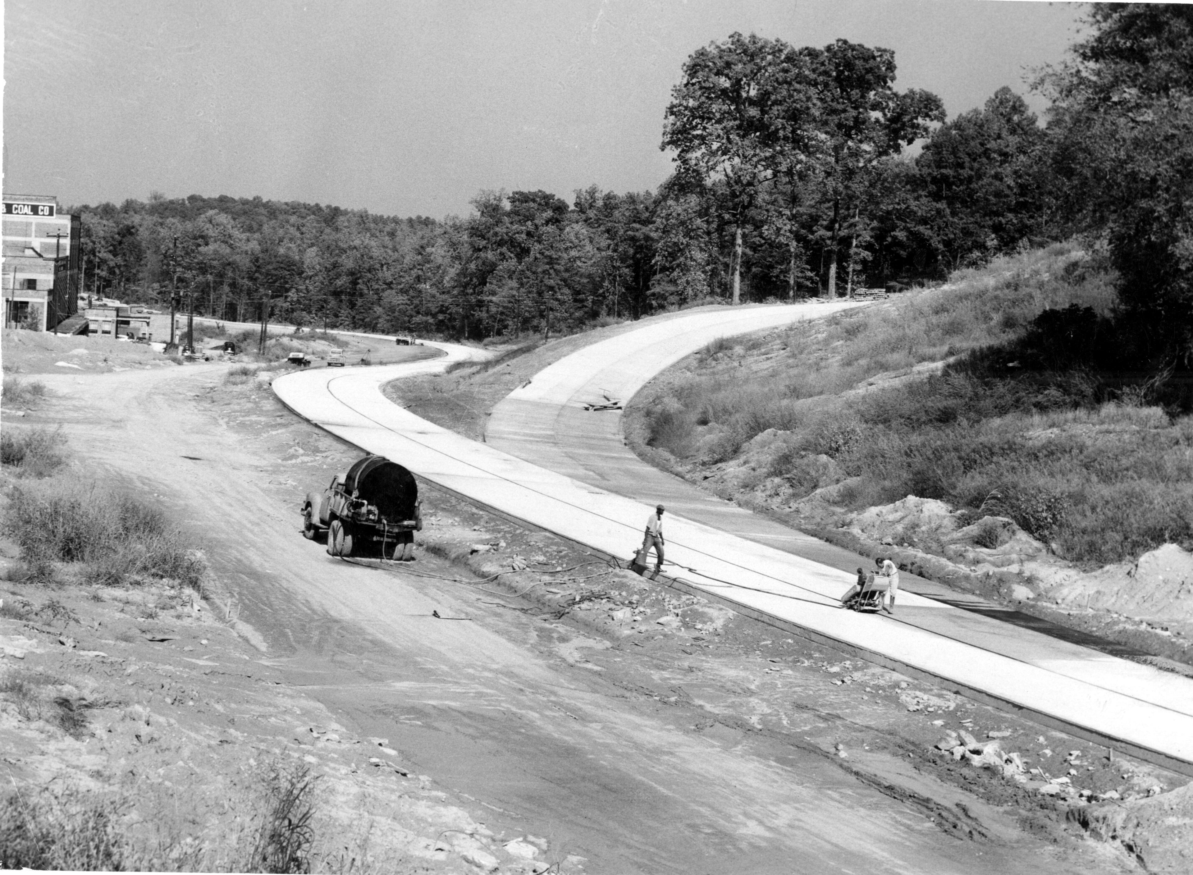 Oct. 1953 - NORTHEAST ATLANTA EXPRESSWAY LEG NEARS COMPLETION. Paving completed on northbound lane and Peachtree cloverleaf turnoff.