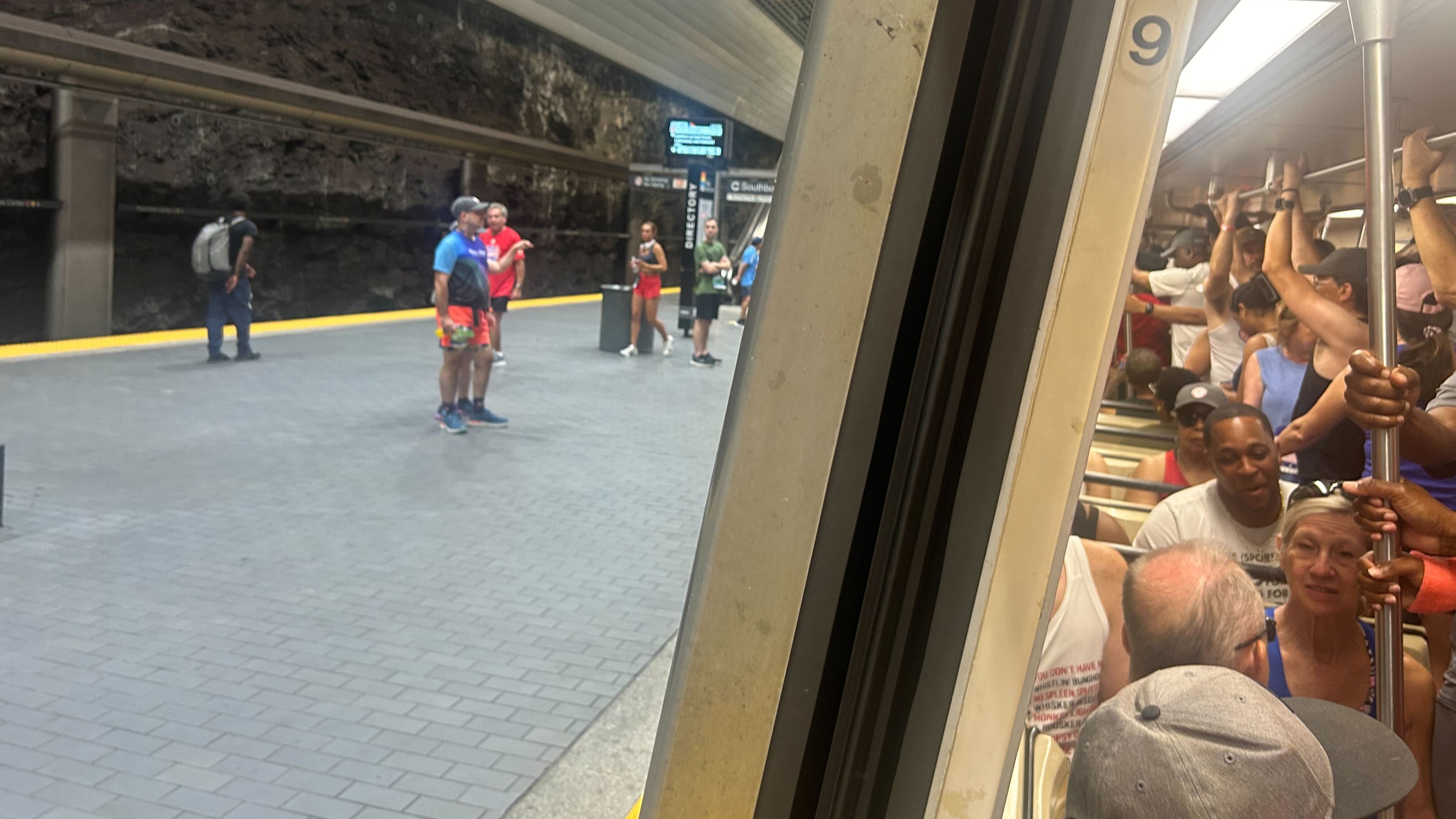 Runners headed to the Peachtree Road Race stand shoulder-to-shoulder on a northbound train leaving Peachtree Center Station around 6:30 a.m. Friday. (Gray Mollenkamp/AJC)