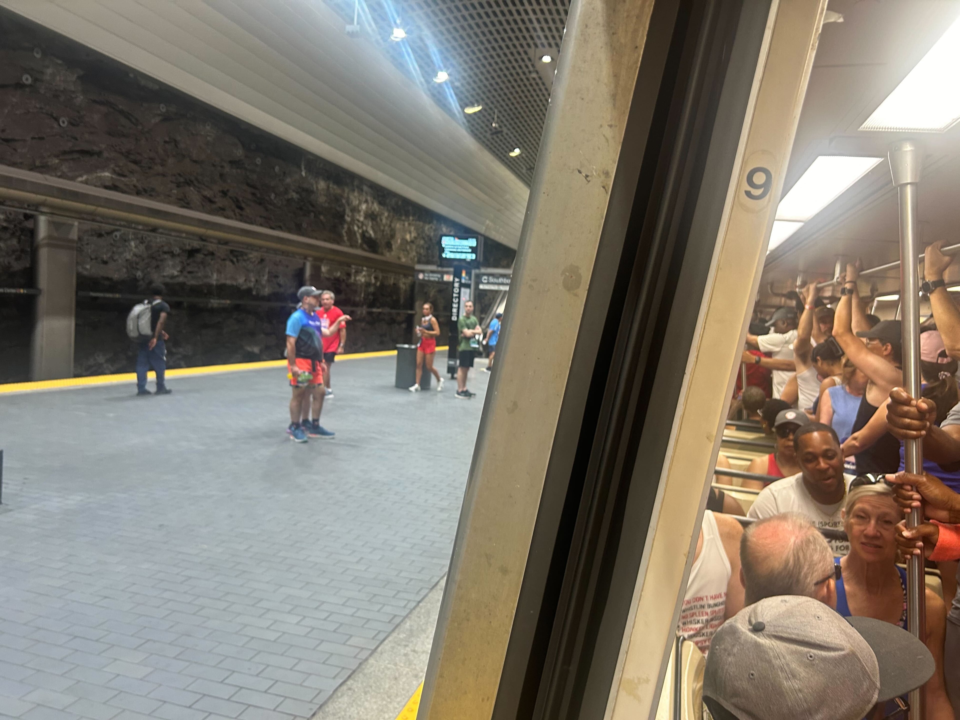 Runners headed to the AJC Peachtree Road Race stand shoulder-to-shoulder on a train leaving Peachtree Center station on Friday, July 4, 2025. A mechanical issue left many riders stranded for up to 45 minutes on one of MARTA’s most important days of the year. (Gray Mollenkamp/AJC)
