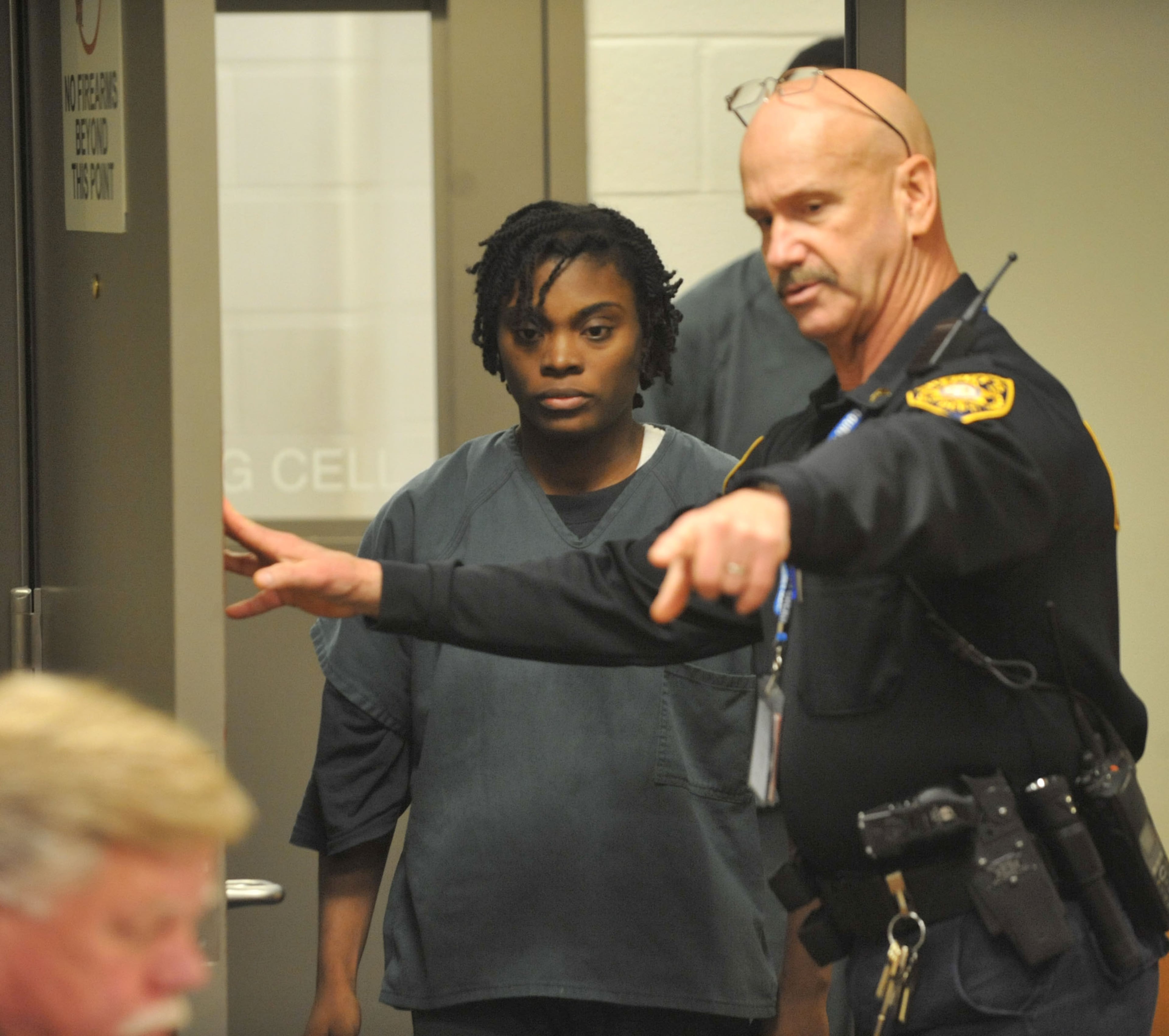 Tiffany Moss enters Magistrate Court Friday afternoon. The parents of Emani Moss are shown during their first court appearance before Gwinnett County Chief Magistrate Kristina Blum in Gwinnett County Magistrate Court Friday November 8, 2013. Eman and Tiffany Moss, of Lawrenceville, Georgia, have been arrested and charged with murder, concealing a body, and child cruelty after police say they had starved to death their daughter, Emani, and then set her body on fire to cover up the crime.