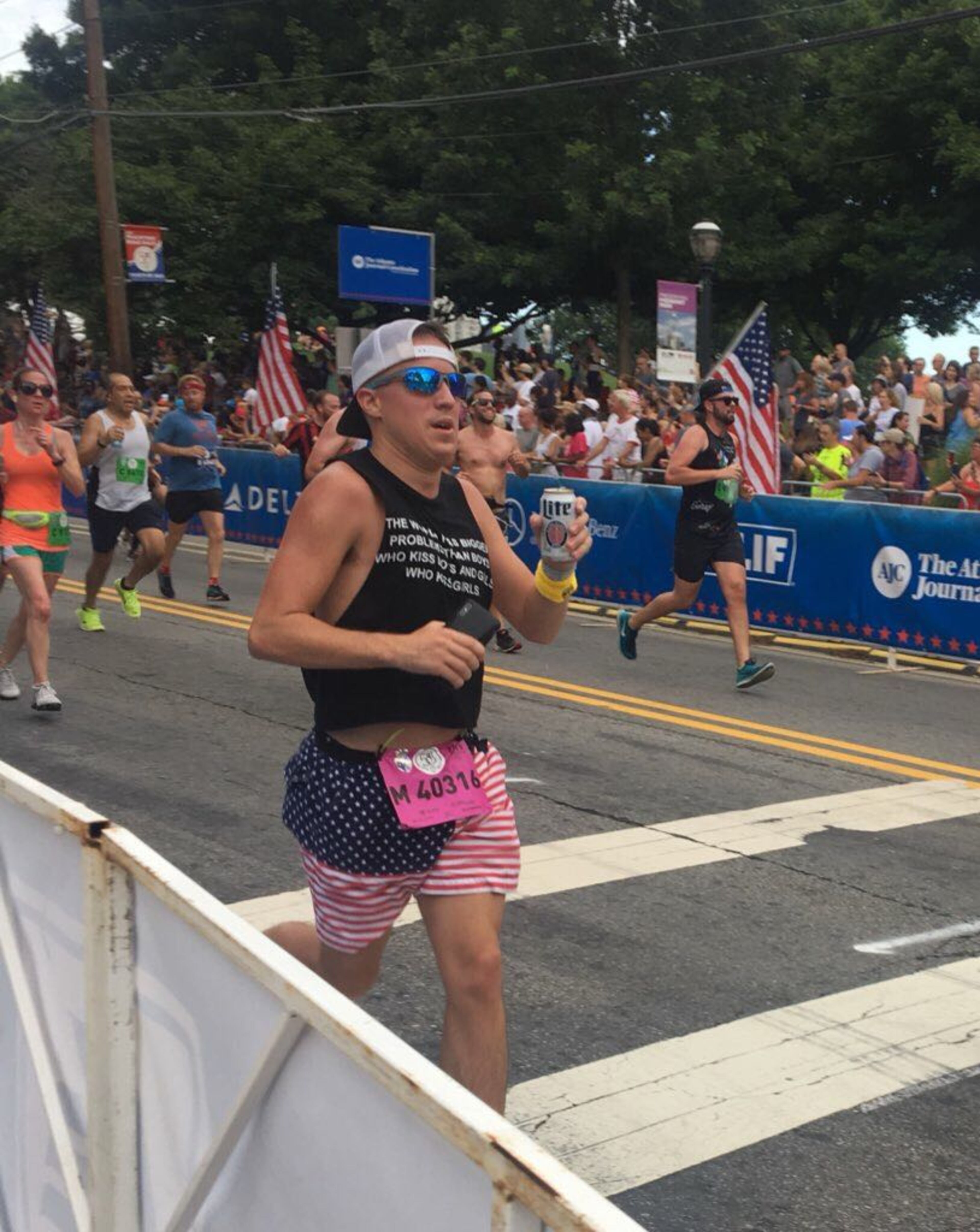 A man running the AJC Peachtree Road Race used the American flag as his costume.