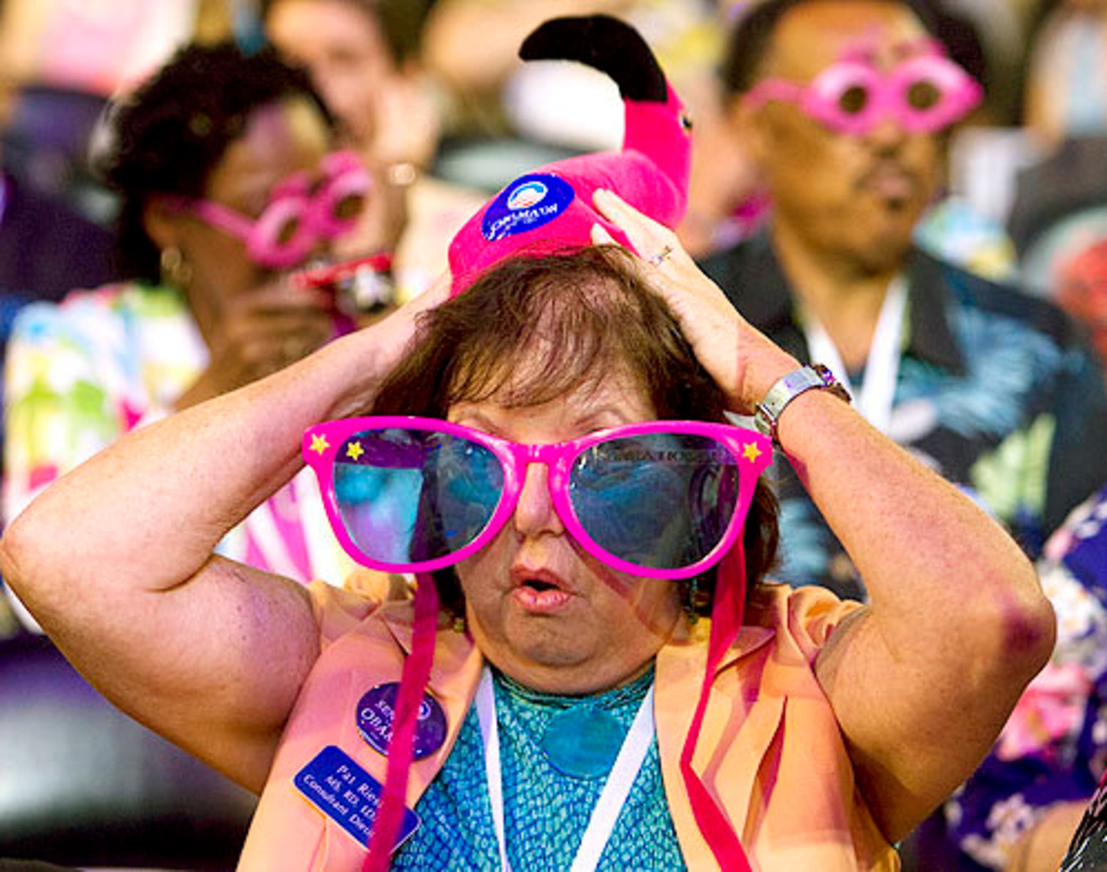 Pat Riester of St. Petersburg, Fla., adjusts her pink flamingo hat.