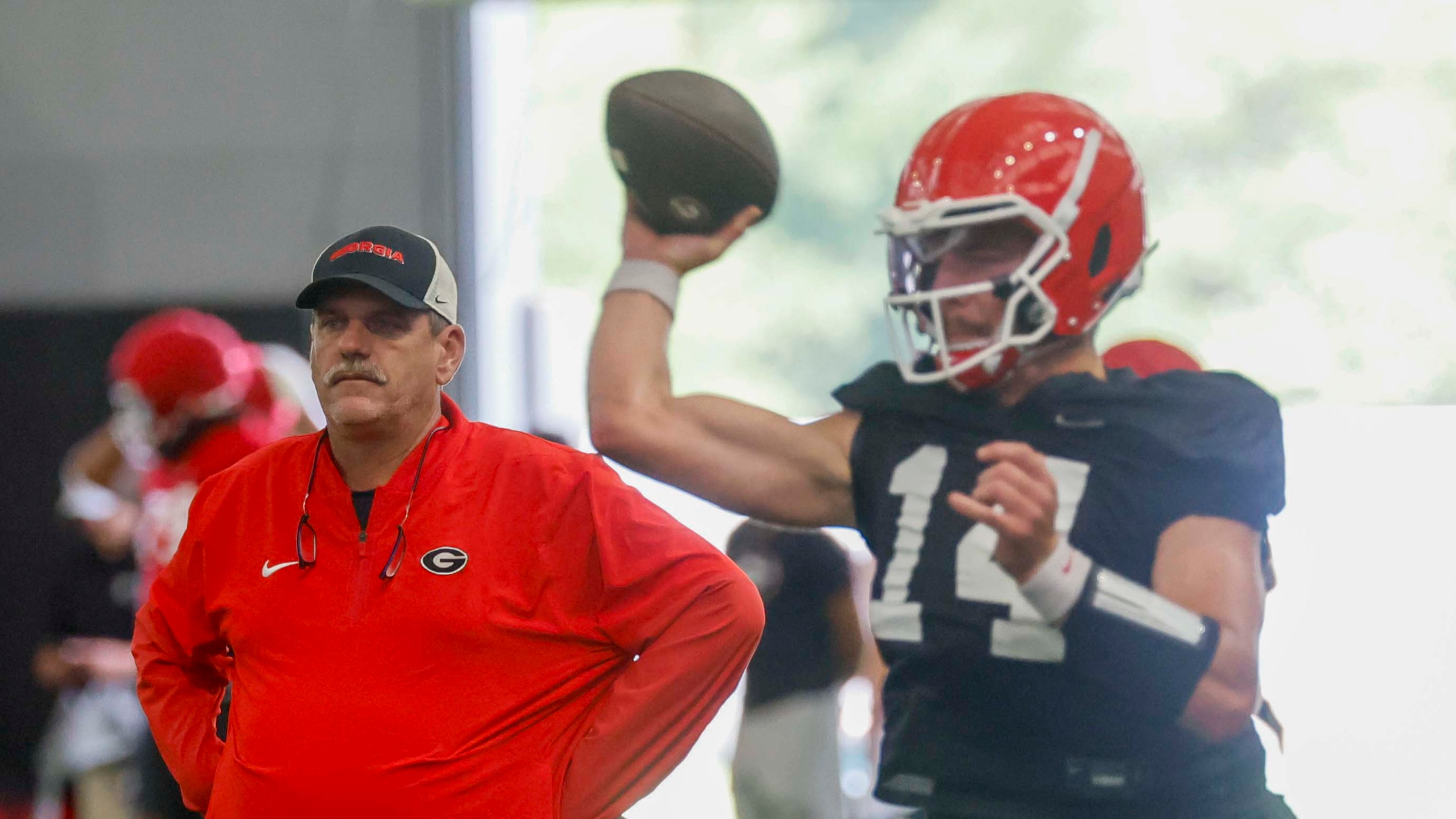 Georgia offensive coordinator Mike Bobo watches quarterback Gunner Stockton (14) throw a pass during their first football practice at the University of Georgia practice facility, Wednesday, August 5, 2026, in Athens, Ga. (Miguel Martinez/AJC)