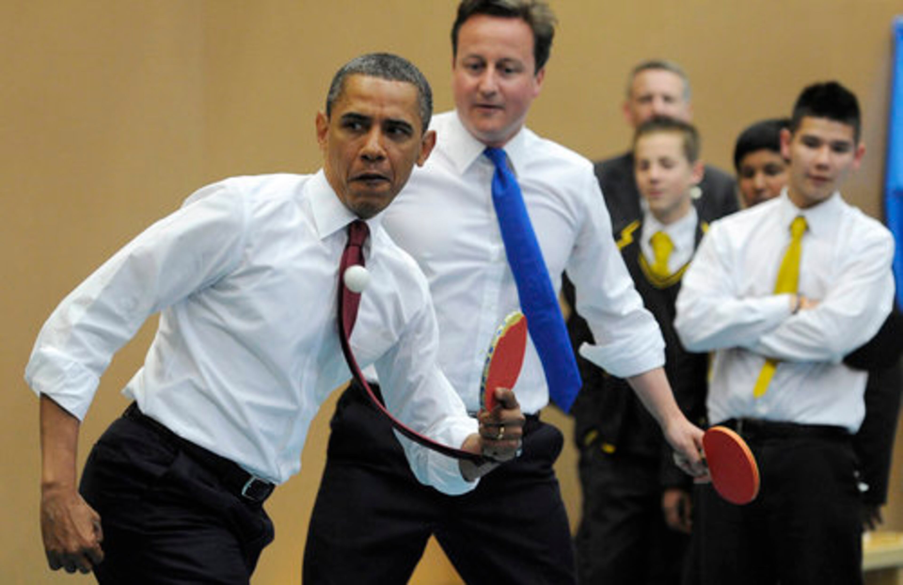 President Barack Obama, left, and Britain's Prime Minister David Cameron play table tennis at Globe Academy, in south London Tuesday.
