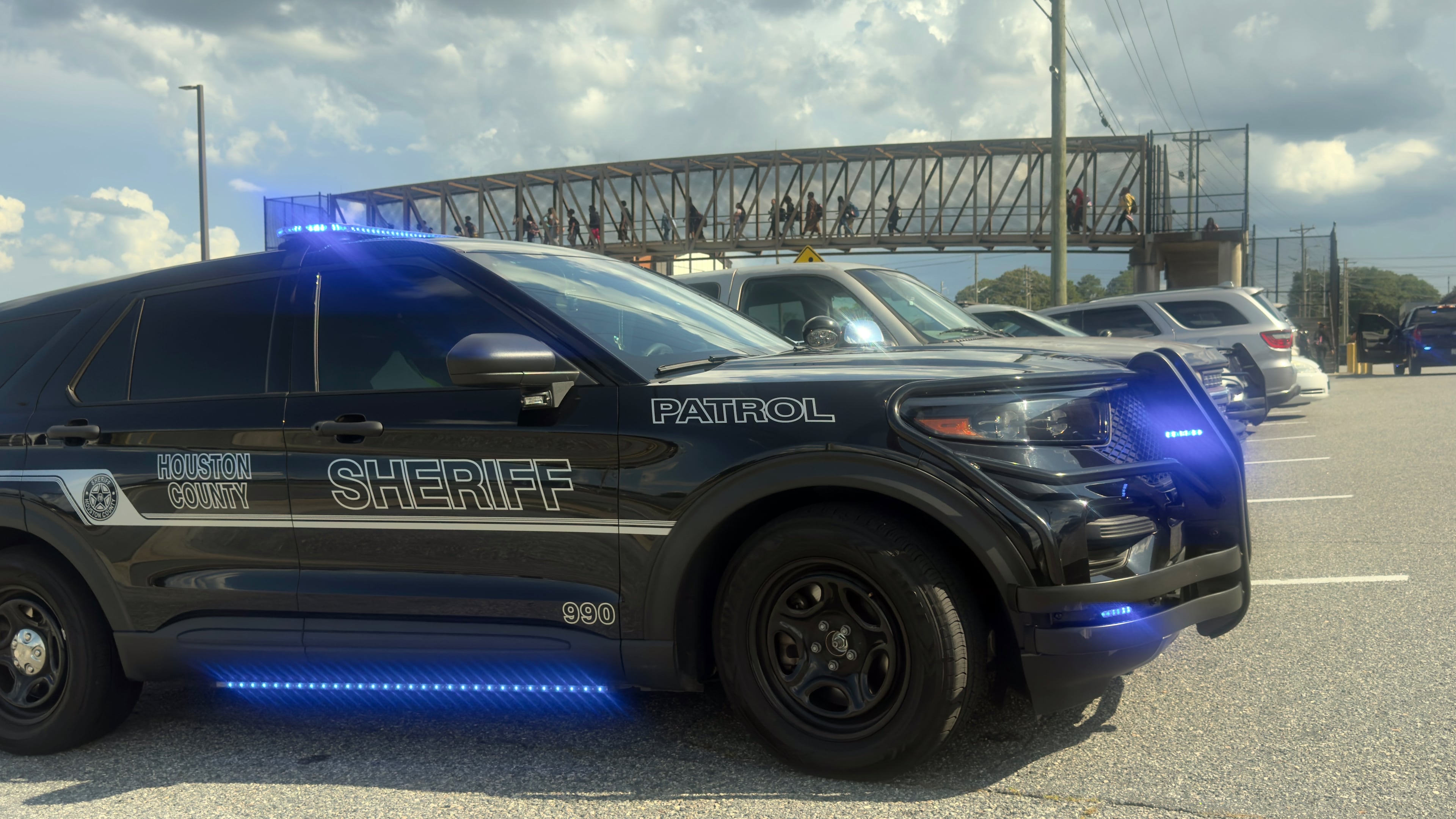 Students leave Warner Robins High School as Houston County Sheriff's vehicles remain on the scene after a shooting on campus left one injured at the Middle Georgia school on Aug. 12, 2026, officials said. Police have a suspect in custody. (Joe Kovac/AJC)