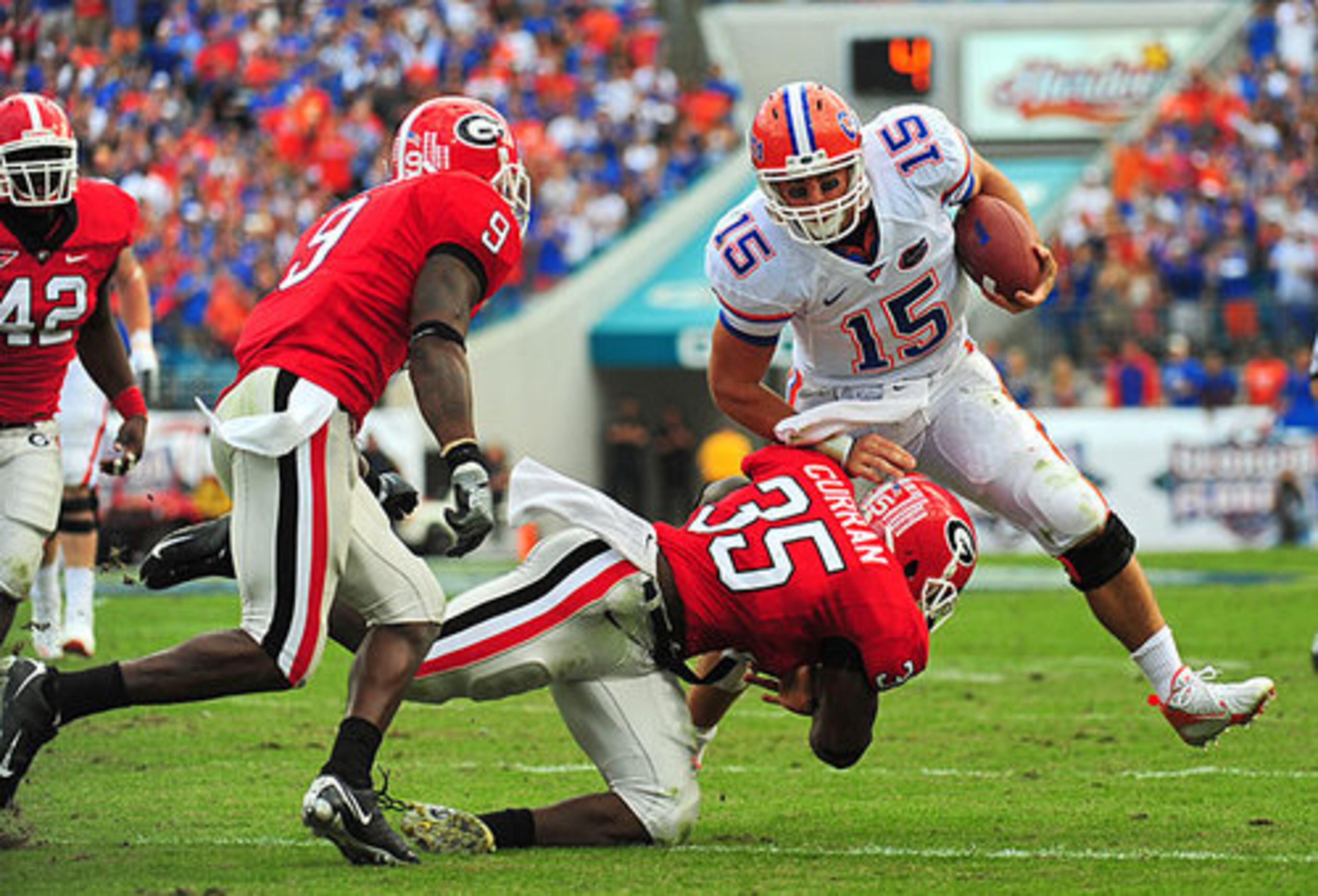Georgia linebacker Rennie Curran grabs a hold of Tebow.