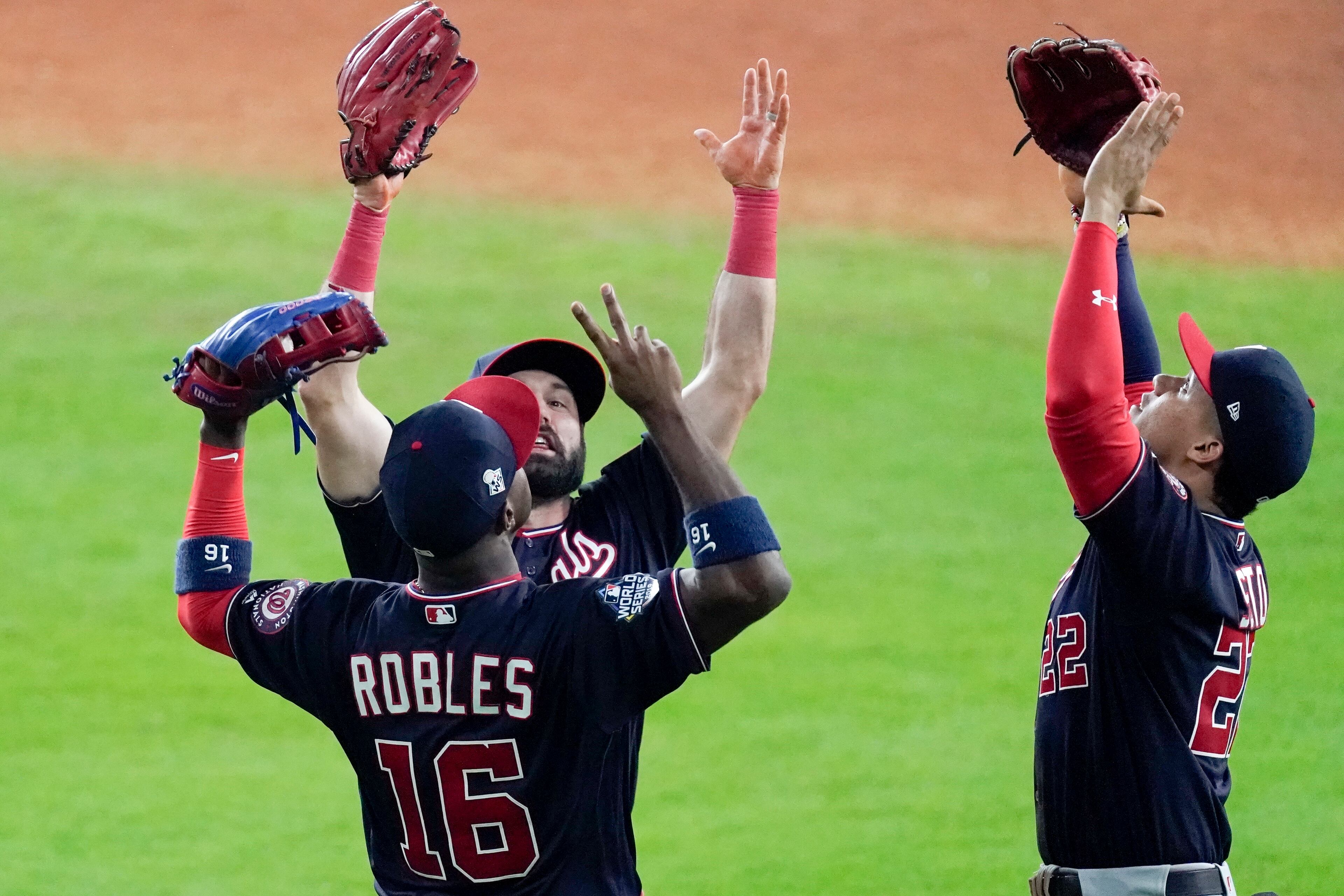 Washington Nationals' Juan Soto, Washington Nationals 2 and Victor Robles celebrate after Game 1 of the baseball World Series against the Houston Astros Tuesday, Oct. 22, 2019, in Houston. The Nationals won 5-4 to take a 1-0 lead in the series. (AP Photo/Eric Gay)
