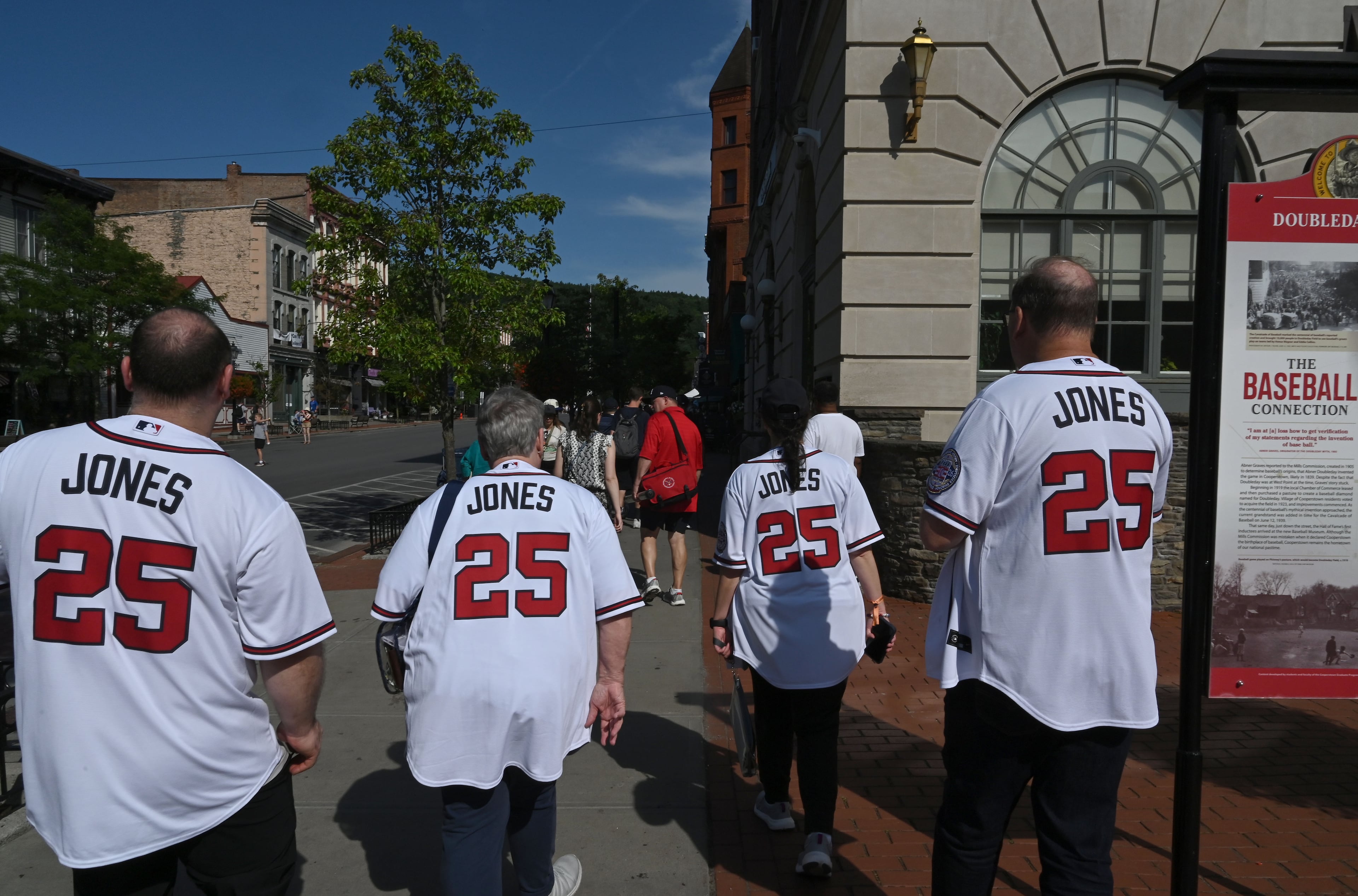 Fans of Atlanta Braves great Andruw Jones stroll through downtown Cooperstown on Friday, July 24, 2026, in Cooperstown, N.Y. Andruw Jones will be inducted into the National Baseball Hall of Fame on Sunday as part of the Class of 2026, alongside Carlos Beltrán and Jeff Kent. He is recognized as one of the greatest center fielders in baseball history. Jones will become the 12th player with ties to the Atlanta Braves to be inducted into the Hall of Fame. (Hyosub Shin/AJC)