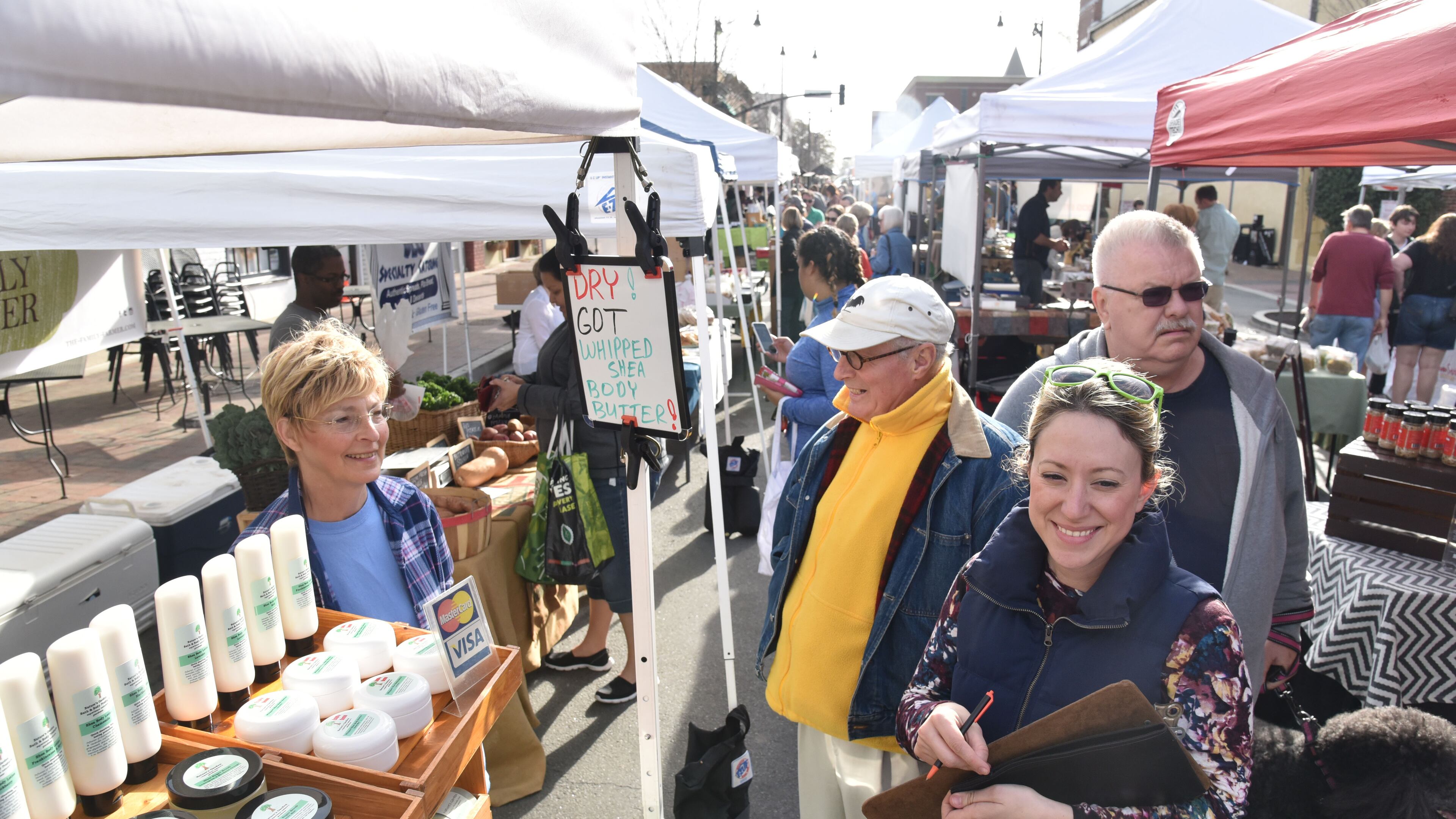 March 25, 2017 Marietta - Candy Odaffer (left), owner of Nature's Garden Soaps, talks with Johnny Fulmer (center), market director, and Heather Kaiserlian (foreground), assistant director, at Marietta Square Farmers Market on Saturday, March 25, 2017. HYOSUB SHIN / HSHIN@AJC.COM