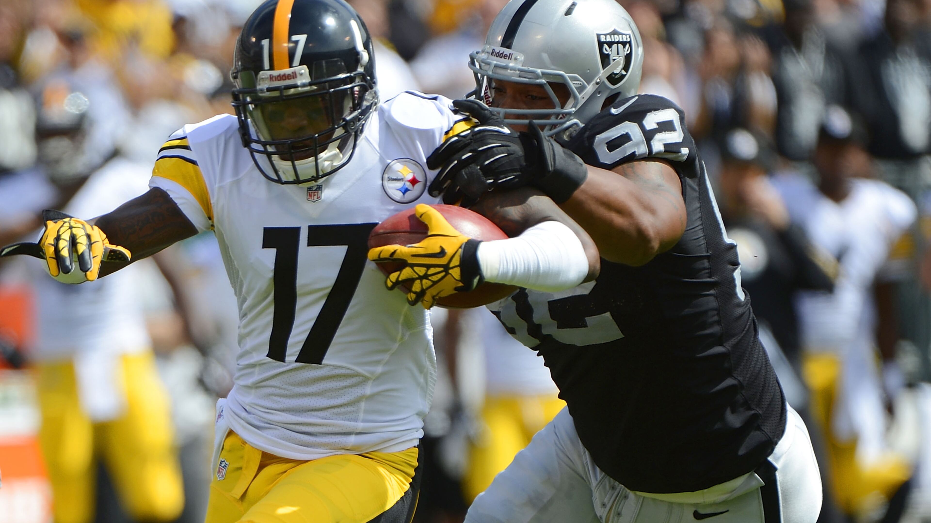 Former Raiders defensive lineman Richard Seymour, who played collegiately at the University of Georgia, catches Mike Wallace of the Steelers during the first quarter of a game at Oakland-Alameda County Coliseum on September 23, 2012, in Oakland, California.