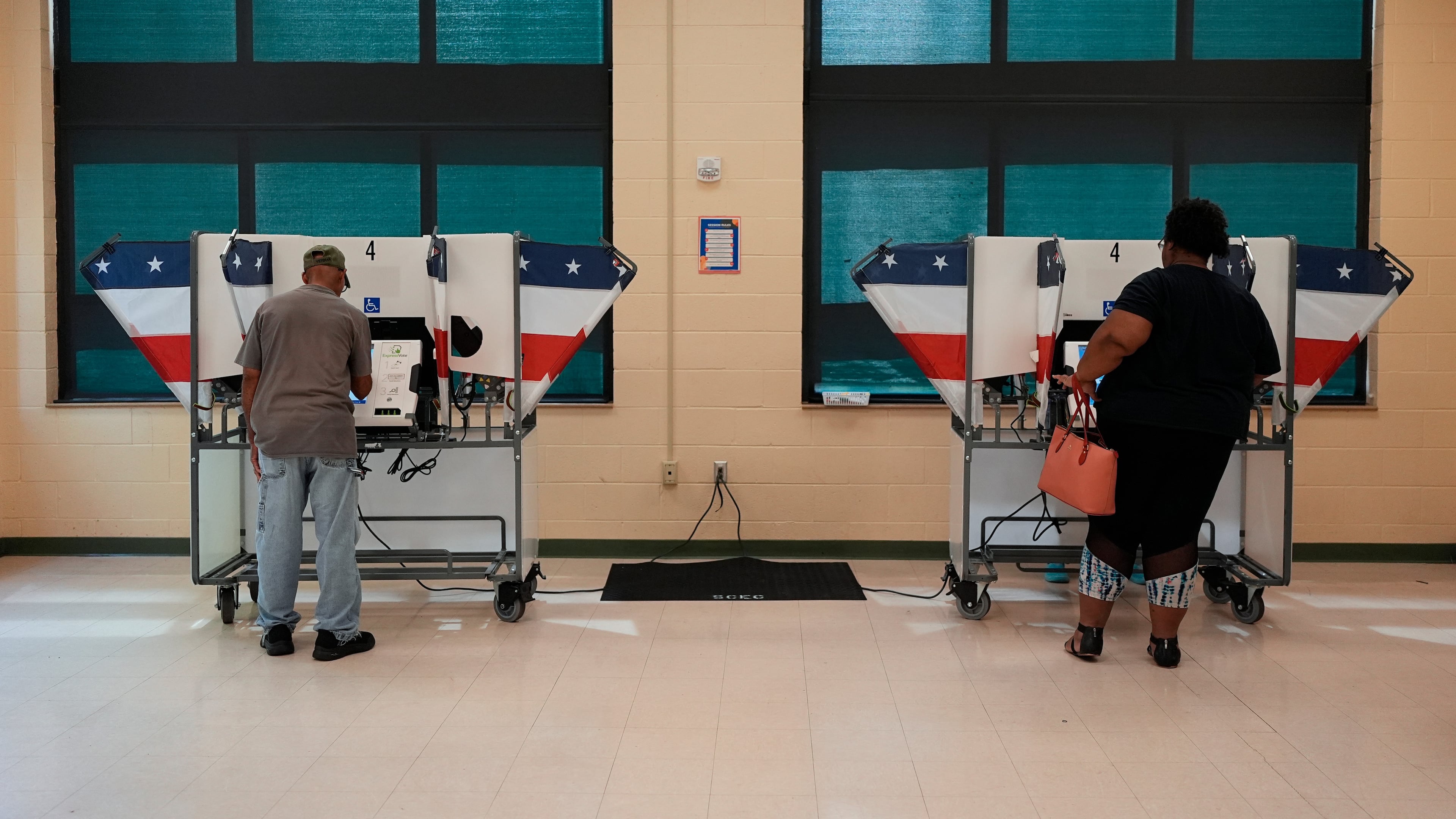 People vote at a polling place in a primary election Thursday, Aug. 6, 2026, in Memphis, Tenn. (AP Photo/George Walker IV)