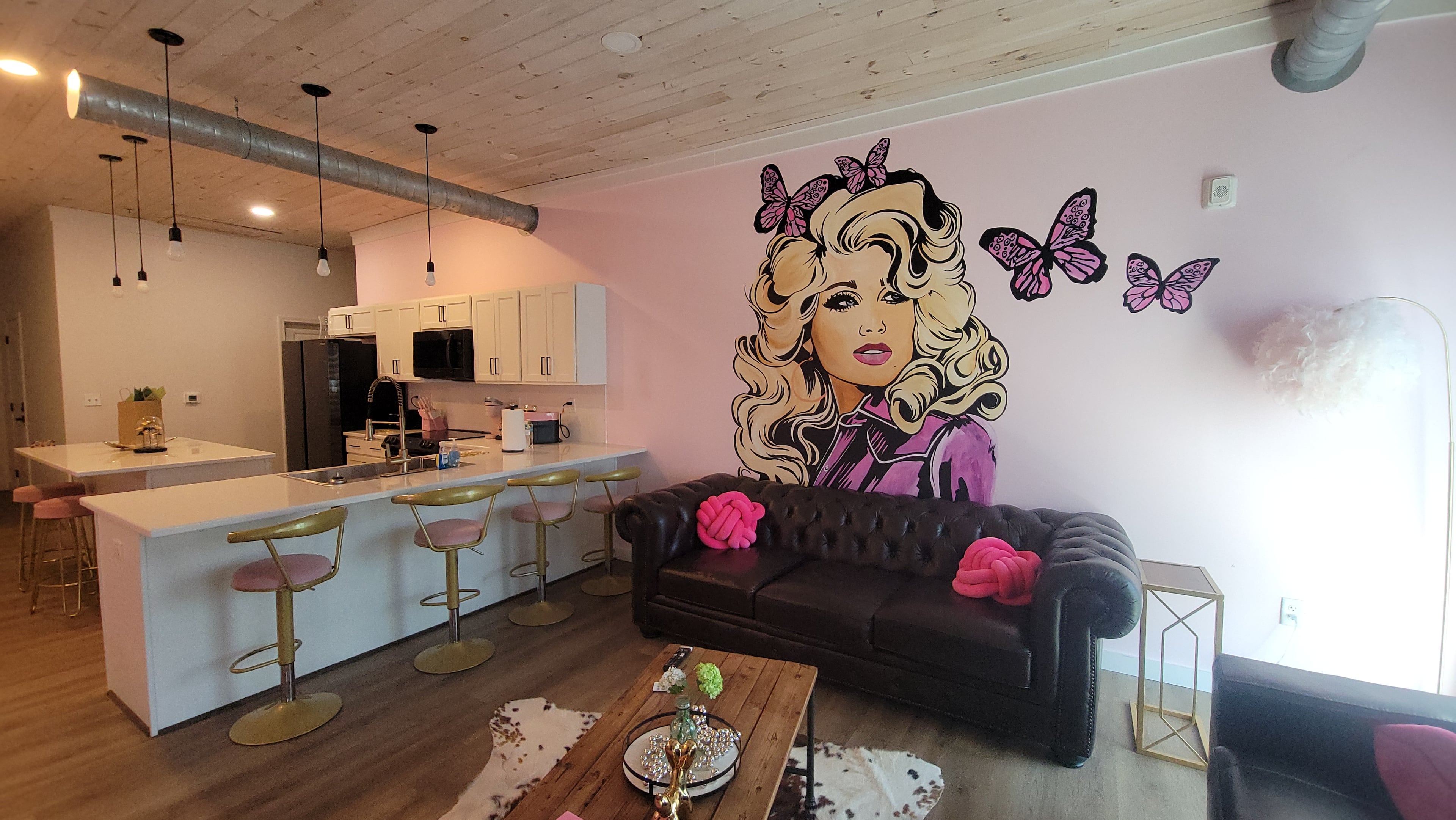 A mural of Dolly Parton adds a colorful tribute to the country music icon inside Dolly's Loft, an Airbnb in Sevierville, Tennessee. (Tracey Teo for the AJC)