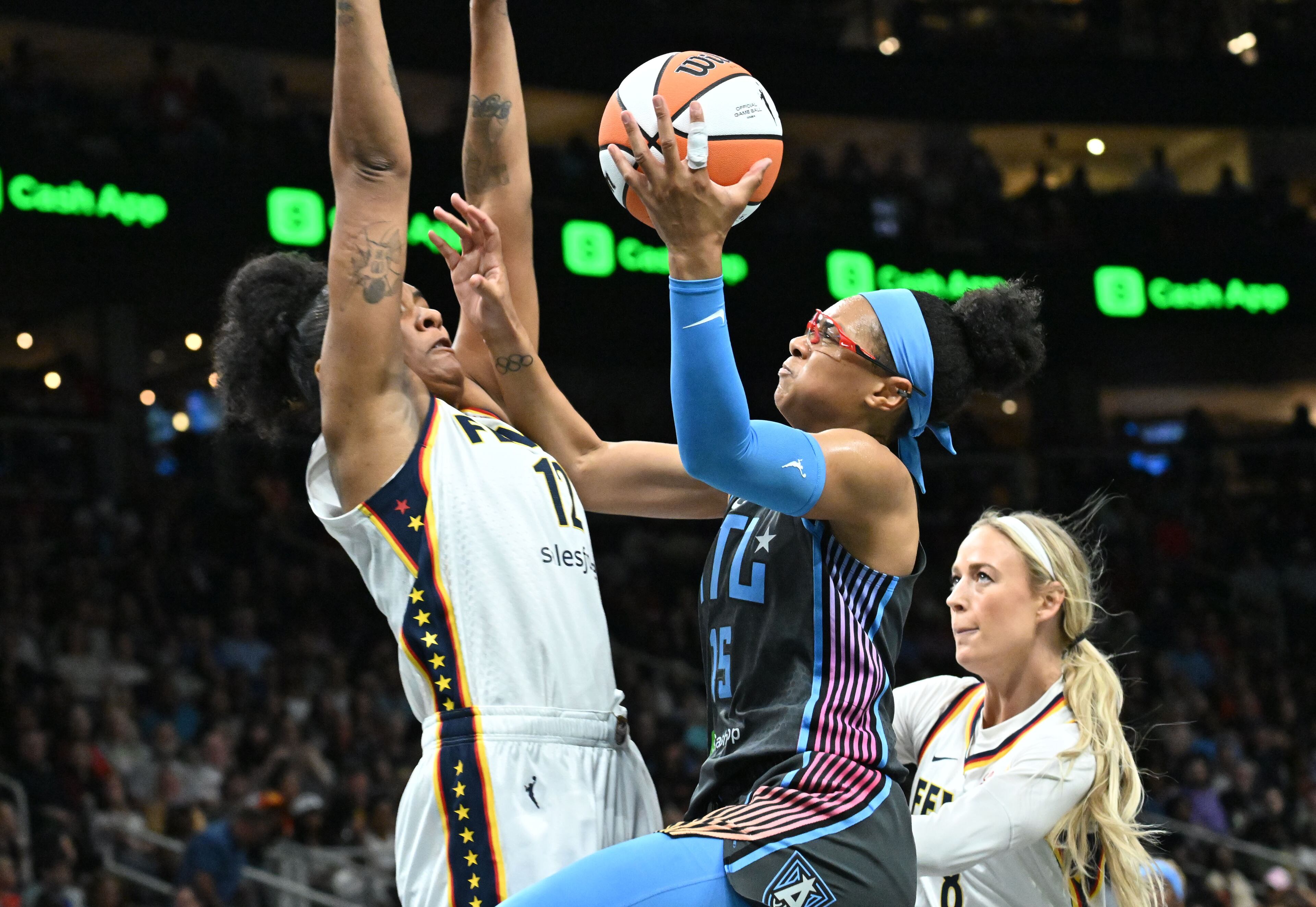 Atlanta Dream guard Allisha Gray (15) goes to the basekt against Indiana Fever forward Damiris Dantas (12) for the shot during the first half in Atlanta Dream’s home opener at State Farm Arena, Thursday, May 22, 2025, in Atlanta. (Hyosub Shin / AJC)