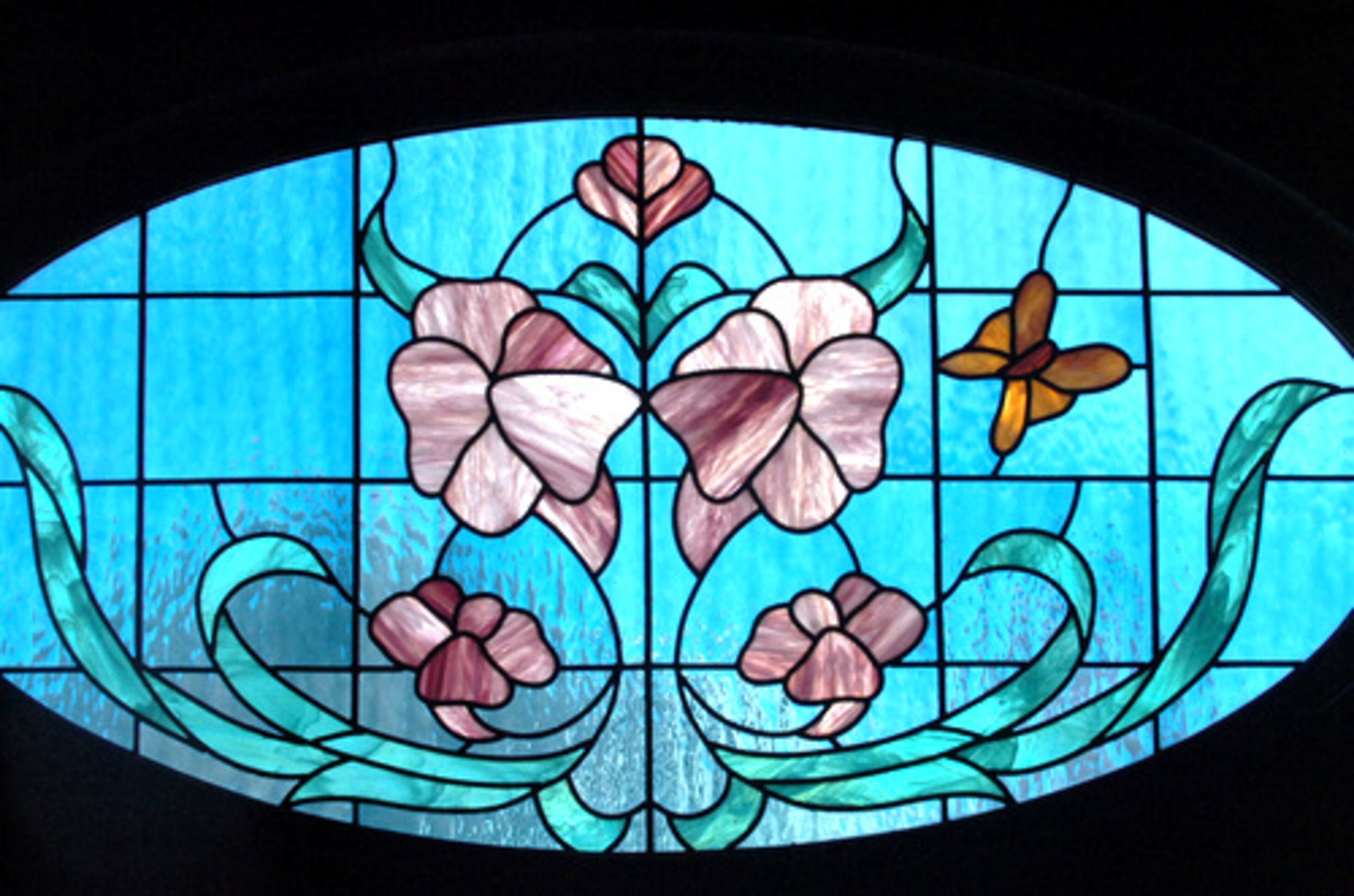 A stained-glass window in one of the bedrooms was added during a previous renovation.