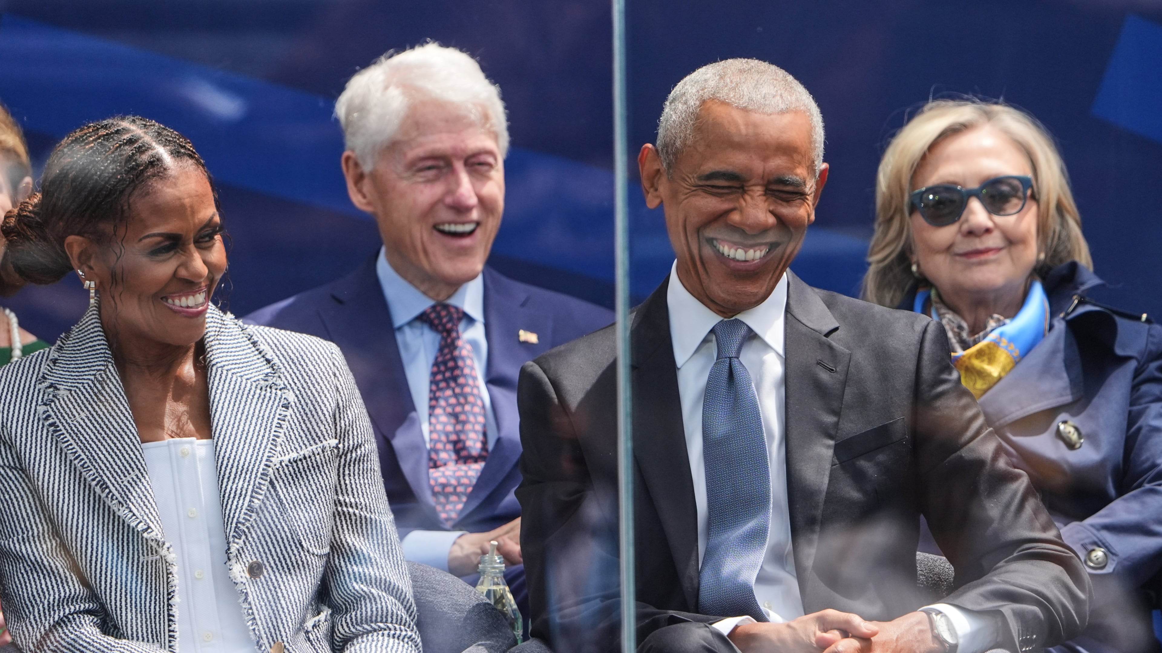 Former President Barack Obama, right, shares a laugh with former first lady Michelle Obama, left, on stage during the dedication ceremony for the Obama Presidential Center, Thursday, June 18, 2026, in Chicago. (AP Photo/Jeff Roberson)