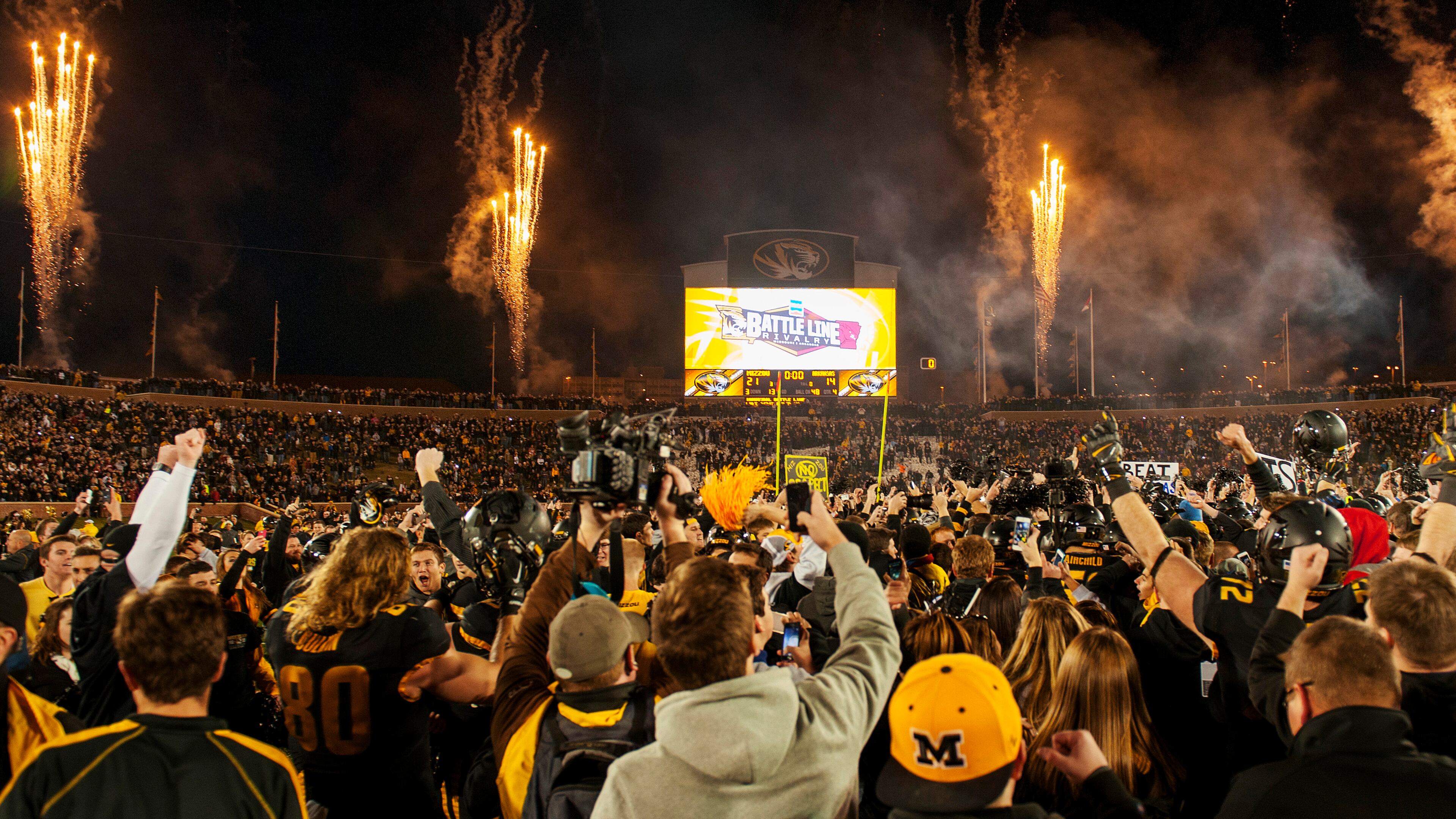 Missouri fans rush the field and celebrate after the team's 21-14 victory over Arkansas in an NCAA college football game Friday, Nov. 28, 2014, in Columbia, Mo. Missouri won 21-14. (AP Photo/L.G. Patterson) Missouri players and fans celebrate a win and the SEC East title. (AP photo)
