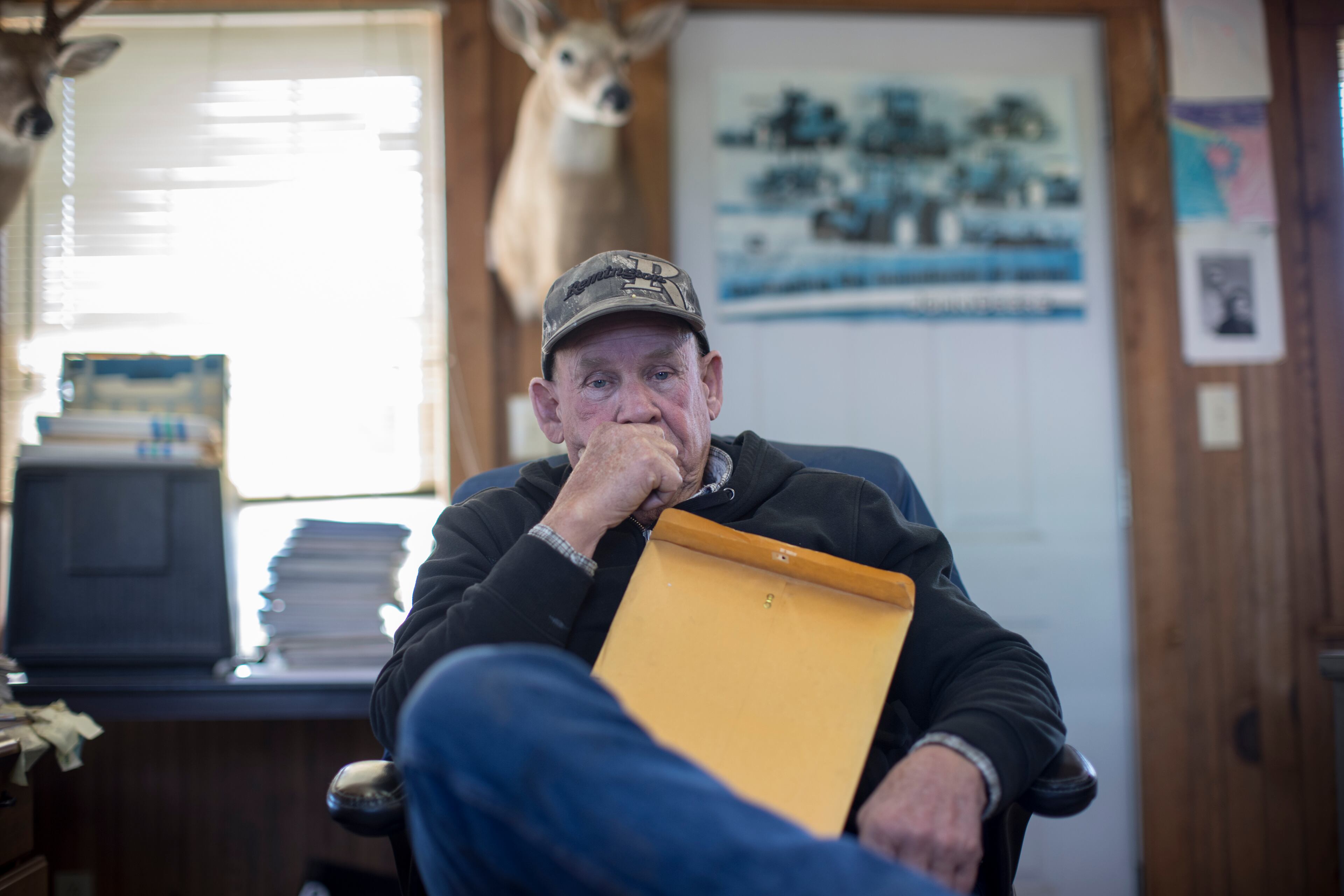 Bulloch County farmer Ray Davis sits in his farm office with documents that map out well sites on Wednesday, Feb. 21, 2024 near Brooklet, Ga. (AJC Photo/Stephen B. Morton)