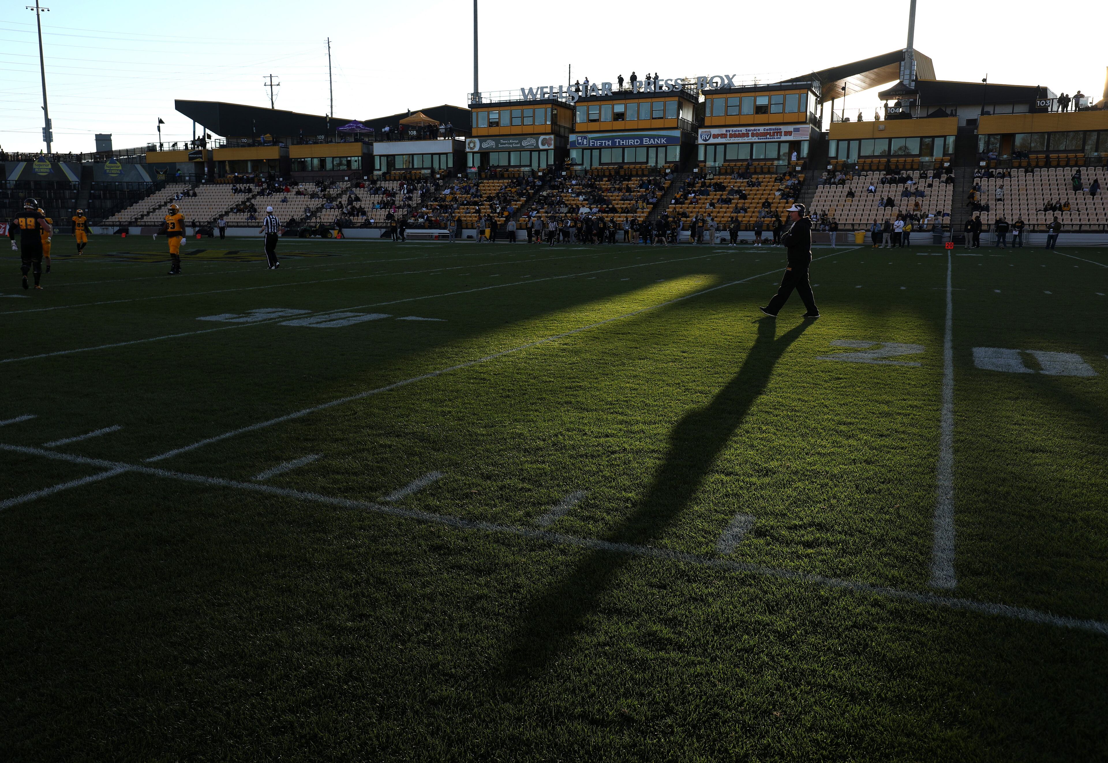 March 22, 2019 - Kennesaw, Ga: Kennesaw State Owls head coach Brian Bohannon, right, walks on the field behind the play during their spring football game at Fifth Third Bank Stadium Friday, March 22, 2019 in Kennesaw, Ga.. (JASON GETZ/SPECIAL TO THE AJC)