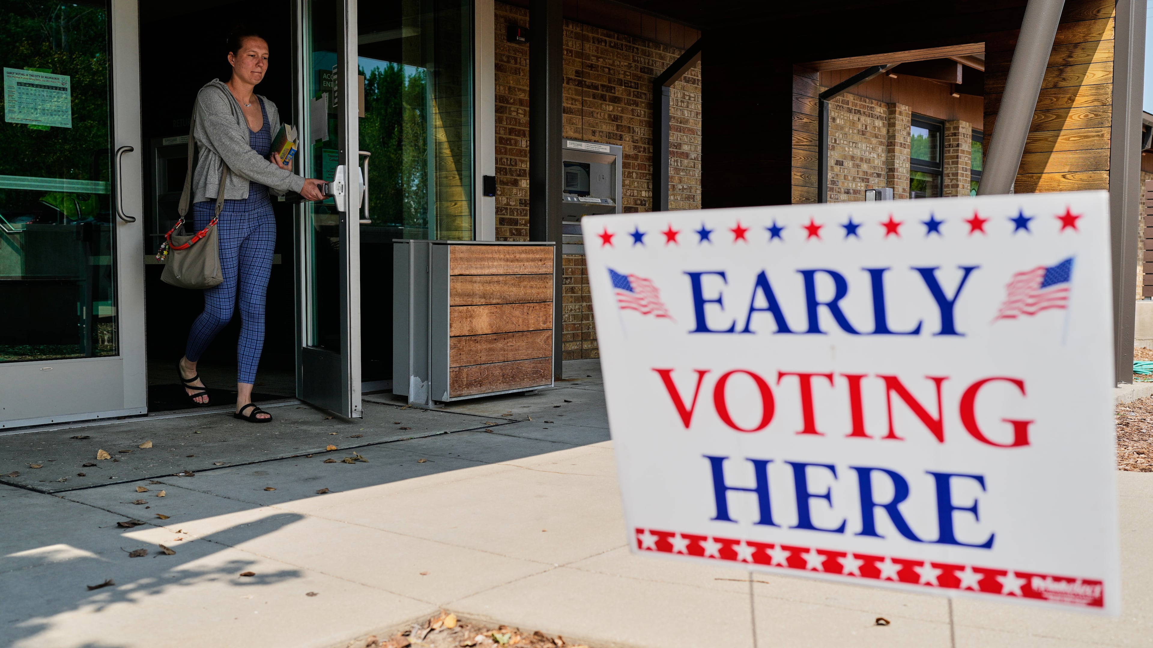 A voter walks out after voting at a polling place, Tuesday, July 28, 2026, in Milwaukee. (AP Photo/Nam Y. Huh)