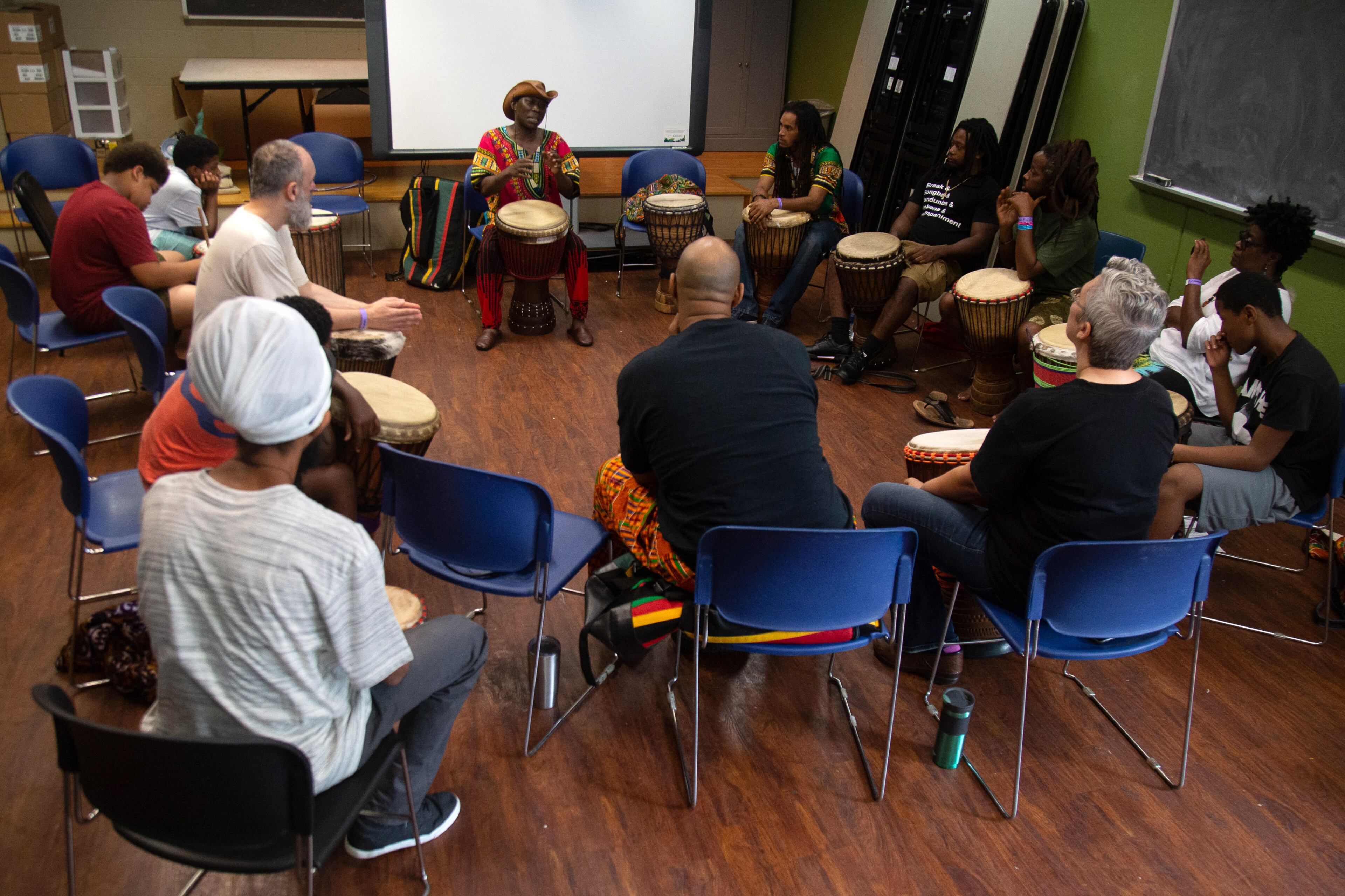 Drum instructor Dr. Dja Bi (C) leads his students during class at the 11th Atlanta African Dance & Drum Festival at the Covenant House of Georgia on Sunday, July 28, 2019. STEVE SCHAEFER / SPECIAL TO THE AJC