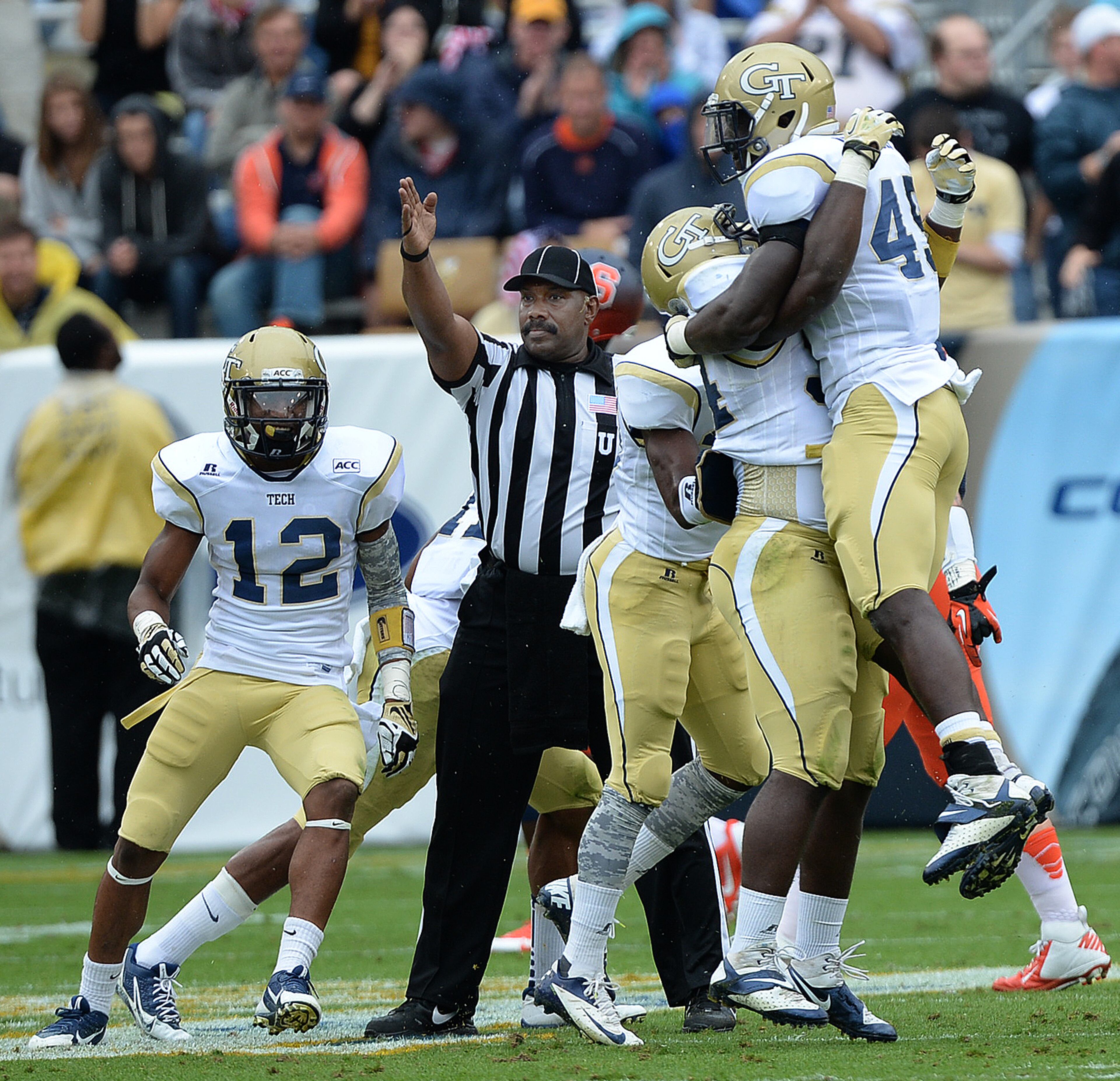 Georgia Tech's Quayshawn Nealy (54) picks Jeremiah Attaochu (45) after the interception in the first half inside Bobby Dodd Stadium against Syracuse University on Saturday, October 19, 2013. Georgia Tech won the game 56-0.