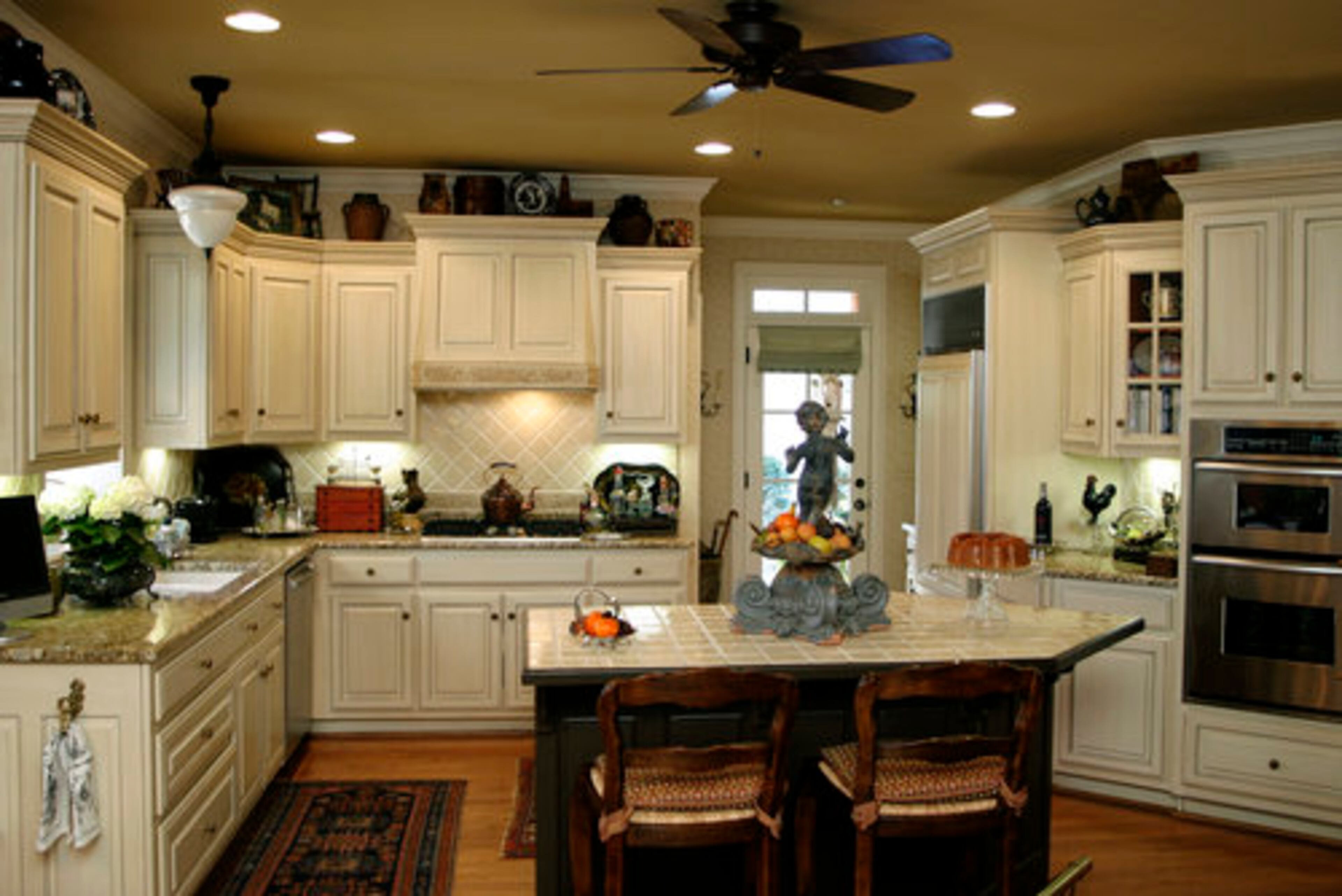 These distressed ivory-colored cabinets are "easy to live with," Martha says, and don't compete with her collection of antique European pottery.