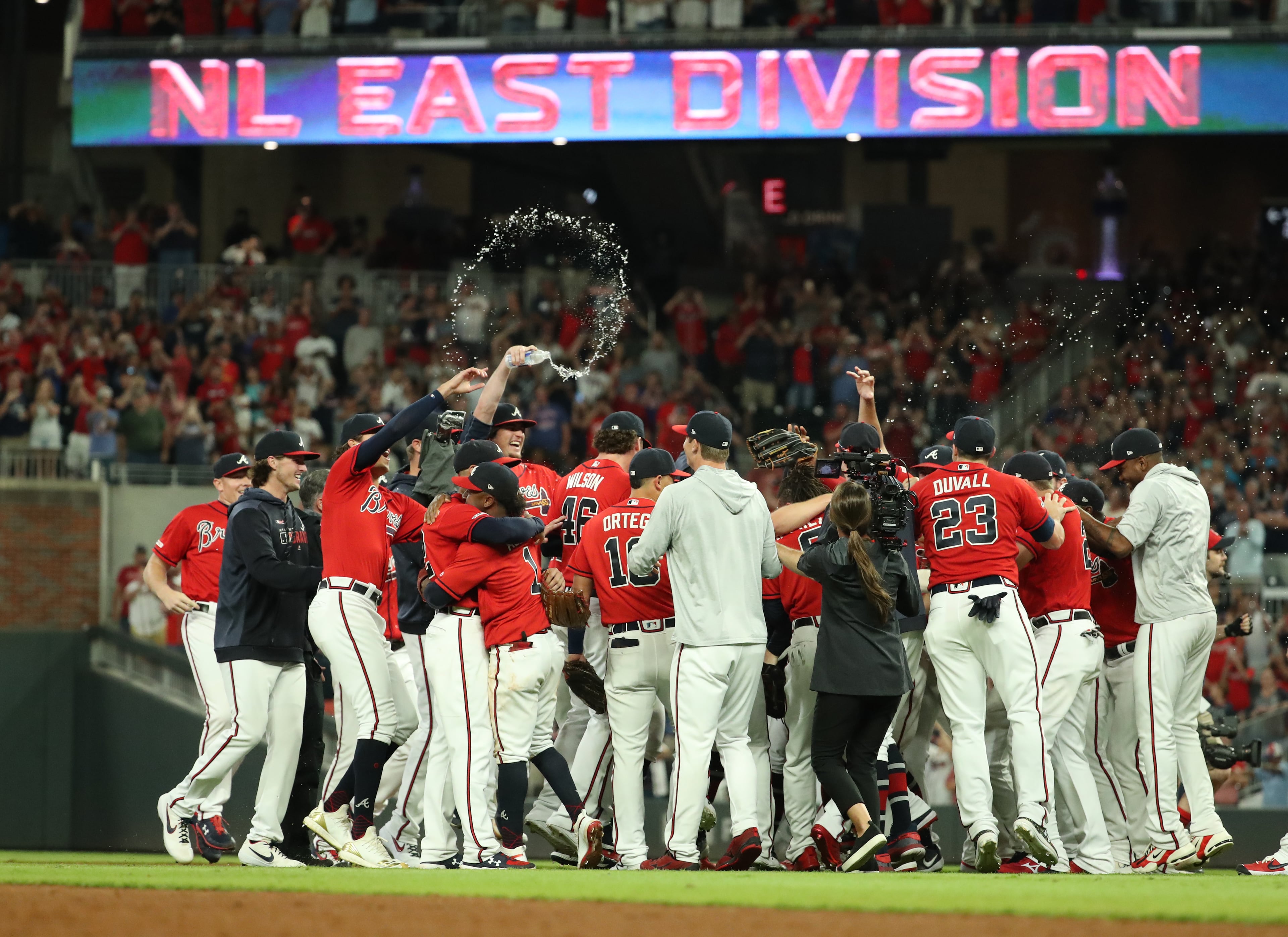 Atlanta Braves players celebrate their 6-0 win against the San Francisco Giants to clinch the NL East.