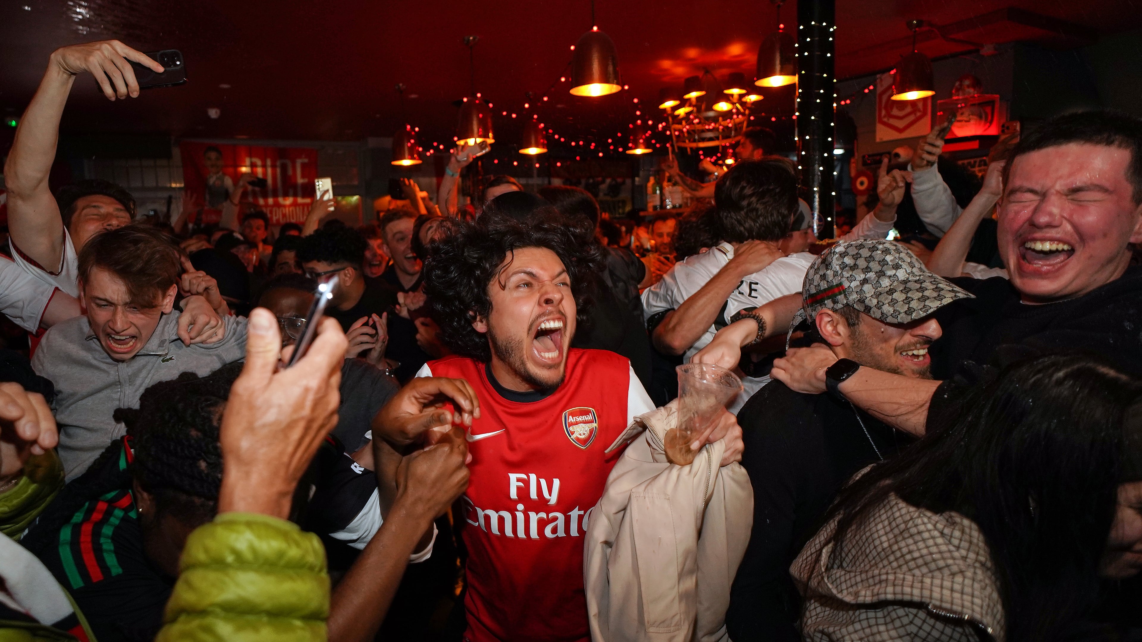 Arsenal supporters celebrate in a pub near the Arsenal stadium after Arsenal's soccer team won the Premier League title in London, Tuesday, May 19, 2026.(AP Photo/Alberto Pezzali)