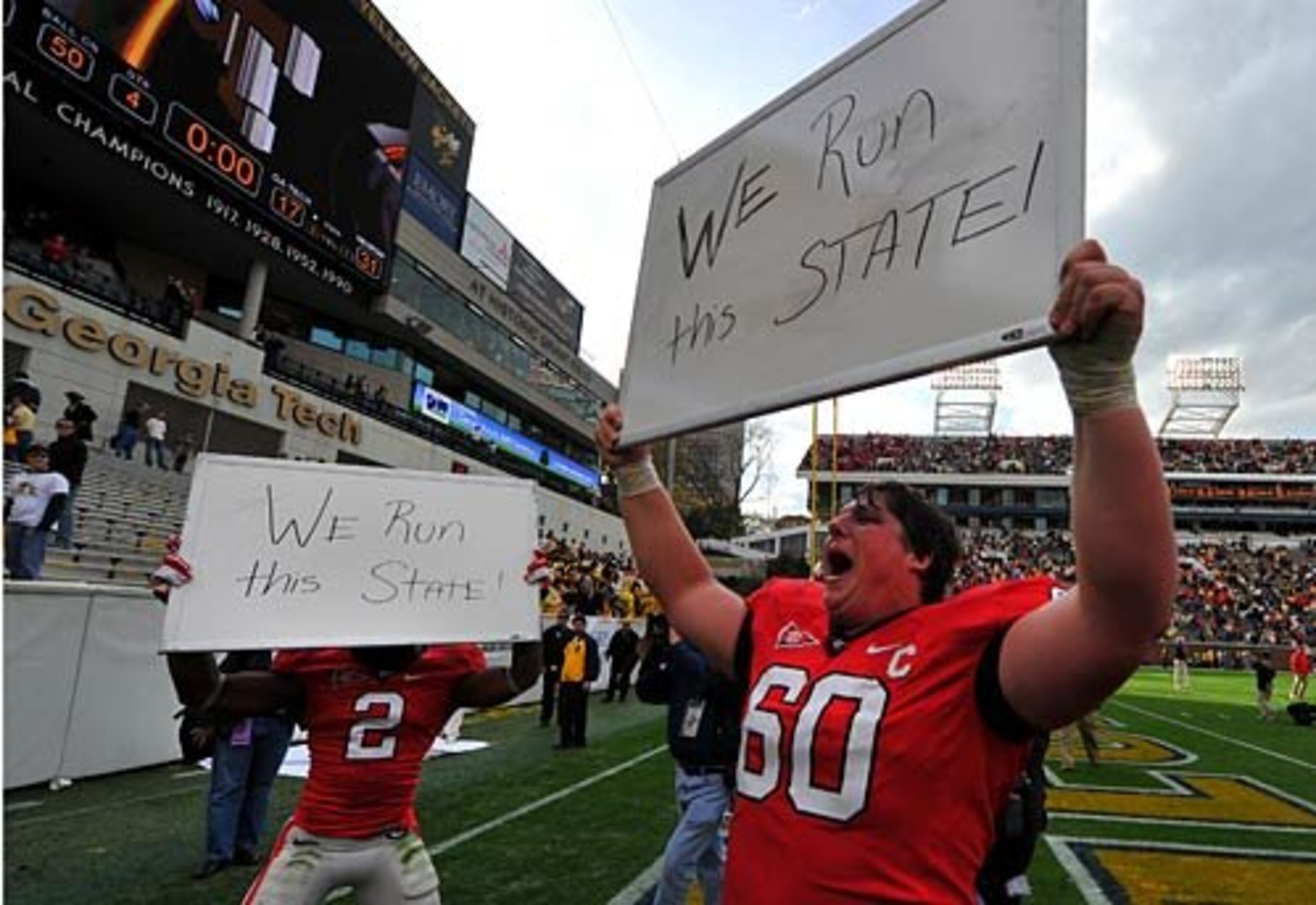 UGA's Brandon Boykin (left) and Ben Jones display what has become one of the fans' favorite unofficial slogans following a Bulldogs' win in the annual Tech-Georgia game: "We Run This State."