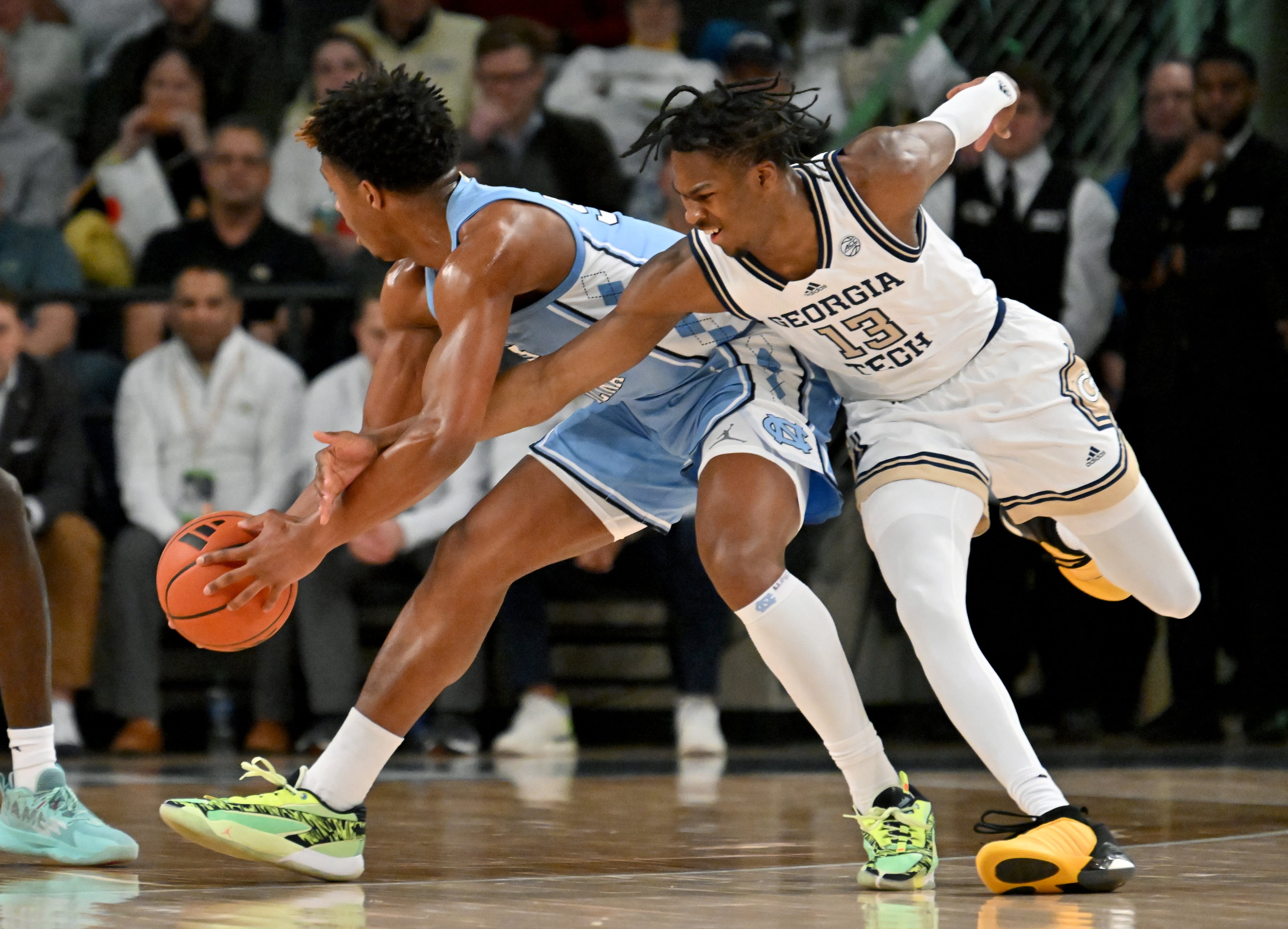 Georgia Tech guard Miles Kelly (13) attempts to steal from North Carolina forward Harrison Ingram (55) during the first half of an NCAA college basketball game at Georgia Tech’s McCamish Pavilion, Tuesday, January 30, 2024, in Atlanta. (Hyosub Shin / Hyosub.Shin@ajc.com)