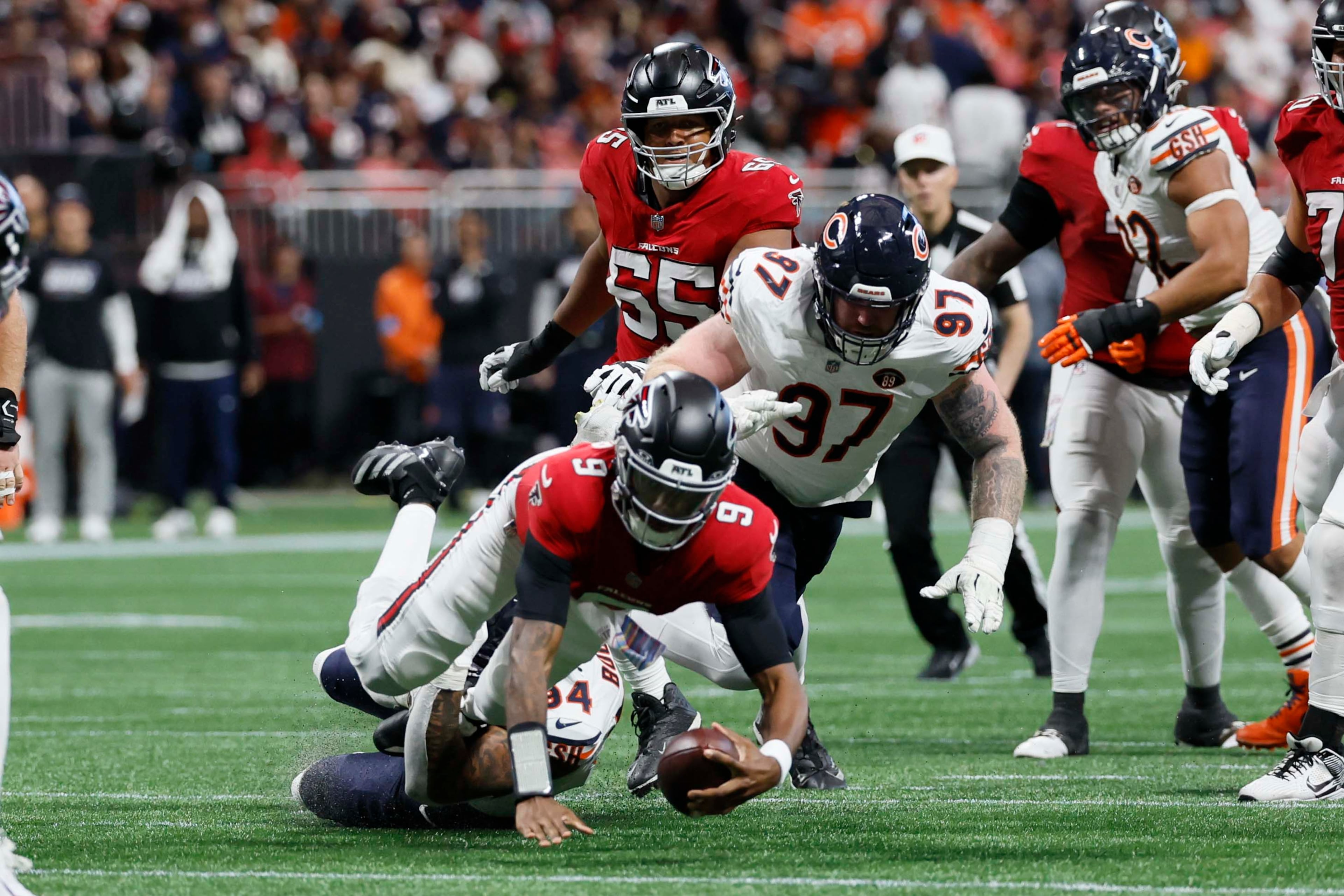 Atlanta Falcons quarterback Michael Penix Jr. is sacked by Chicago Bears defensive end Austin Booker in the second half of an NFL game at Mercedes-Benz Stadium in Atlanta on Sunday, Oct. 18, 2026. (Miguel Martinez/AJC)