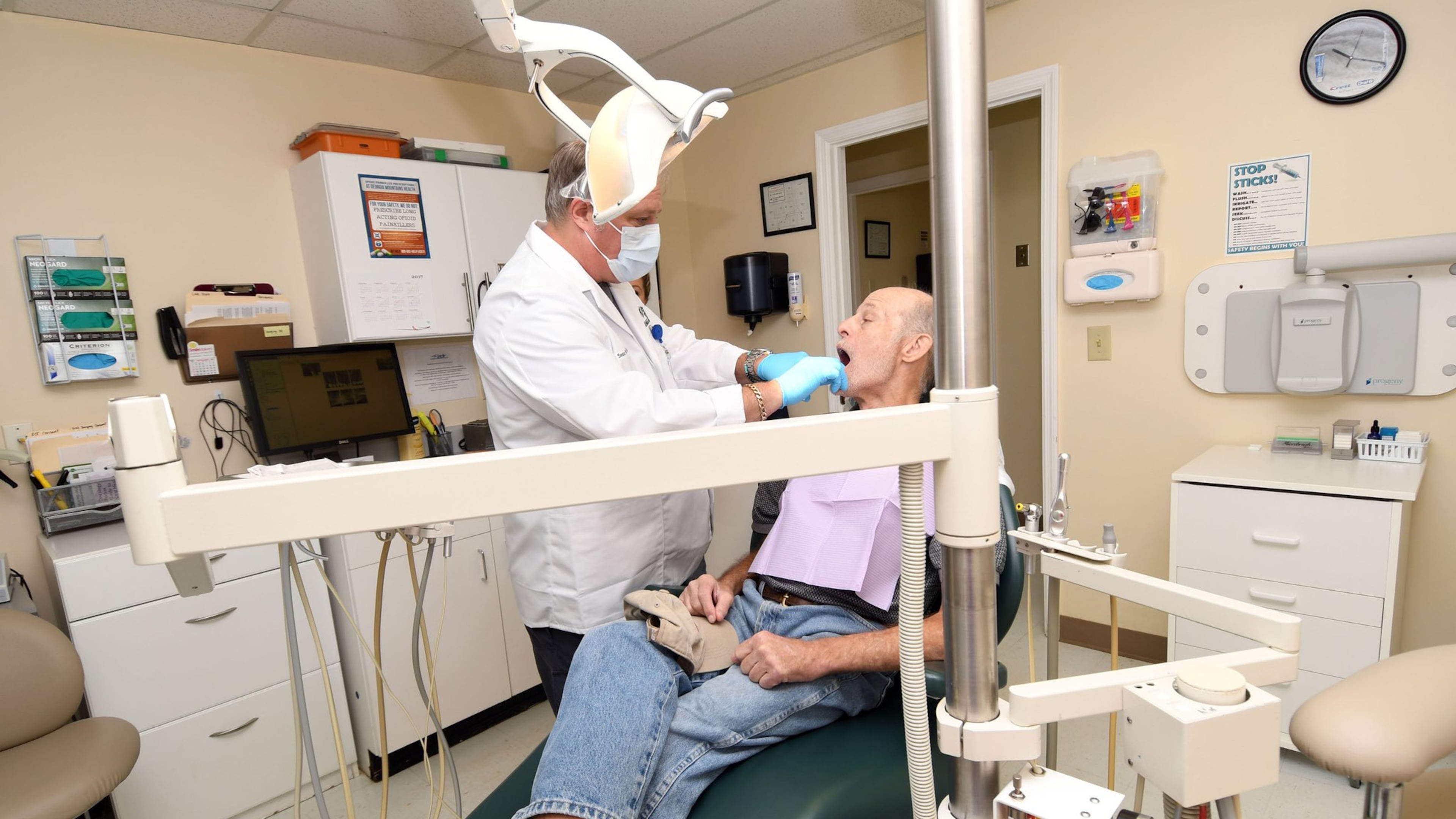Dr. David Sean Van Tuyl examines Michael McClung, of Young Harris, Ga., at the Georgia Mountains Health dental clinic in Blue Ridge. The federal government’s decades-old Community Health Center program saw its funding expire on Oct. 1, but Congress did not renew it. Although the centers are currently on stopgap funding until Dec. 8, the director of the dental clinic is not buying much-needed new dental chairs because he can’t be sure the funding will actually come through. (Photo special to the AJC / Rebecca Breyer)