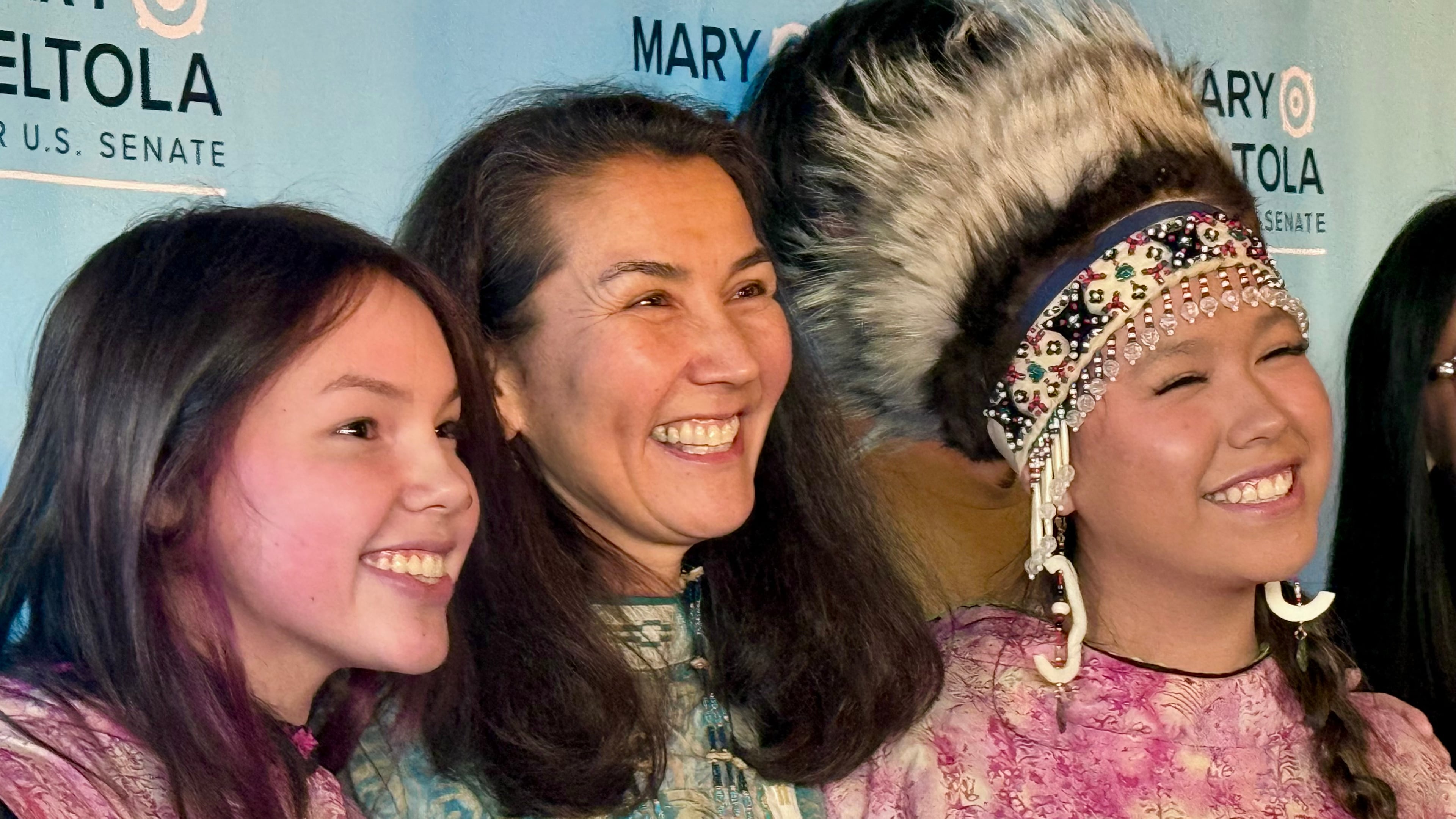 In this photo made with a smartphone, Democratic U.S. Senate candidate Mary Peltola, center, stands with supporters during a campaign event in Anchorage, Alaska, on Wednesday, Oct. 21, 2026. (AP Photo/Haven Daley)
