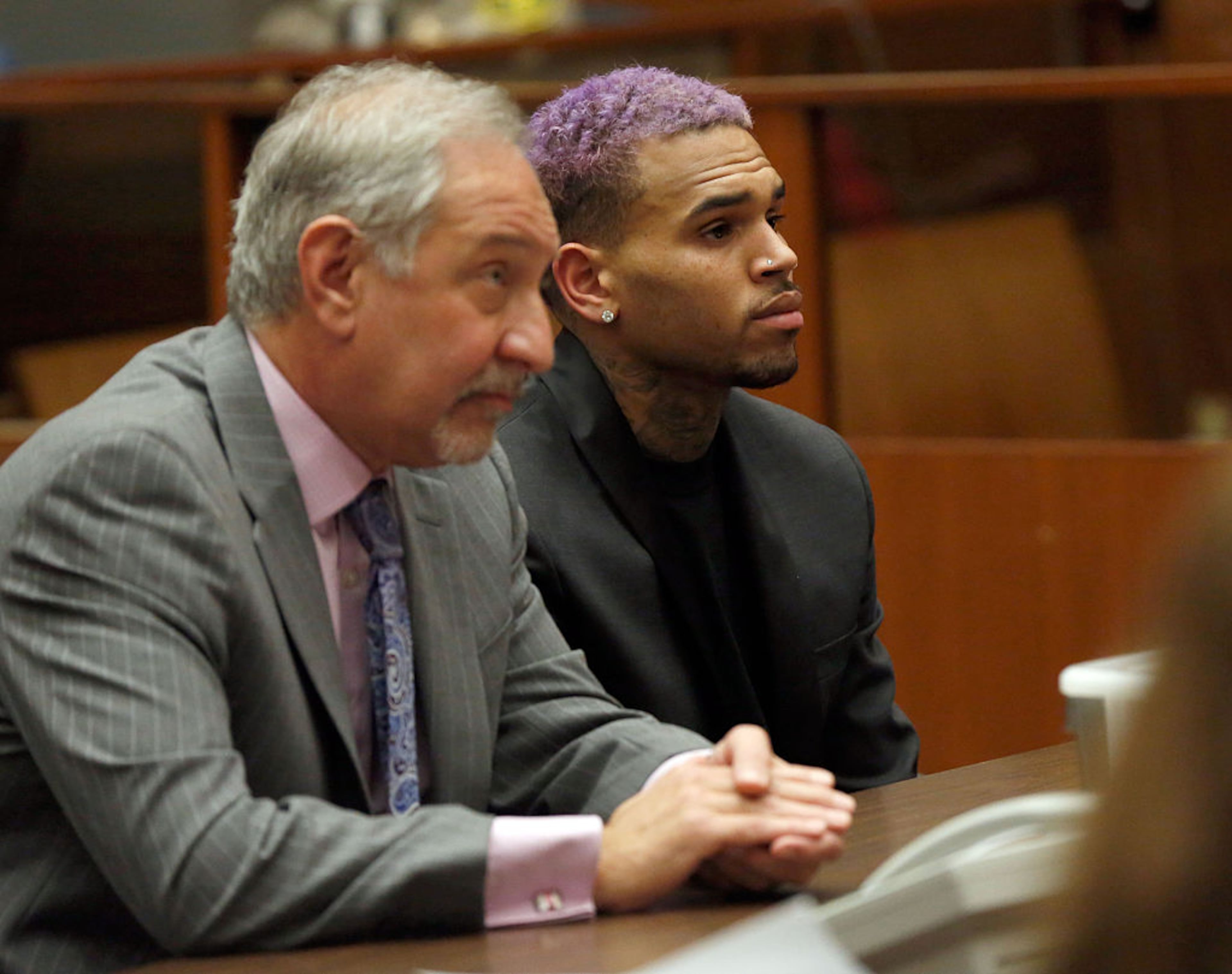LOS ANGELES, CA - MARCH 20: Singer Chris Brown (R) and his lawyer Mark Geragos attend a progress hearing at Los Angeles Superior Court on MARCH 20, 2015 in Los Angeles, California. The judge ended Brown's probation and closed the assault case involving then-girlfriend Rihanna after six years. Brown was first placed on probation after the 2009 domestic violence case in which he plead guilty to assaulting his then-girlfriend, singer Rihanna. (Photo by Mario Anzuoni-Pool/Getty Images)