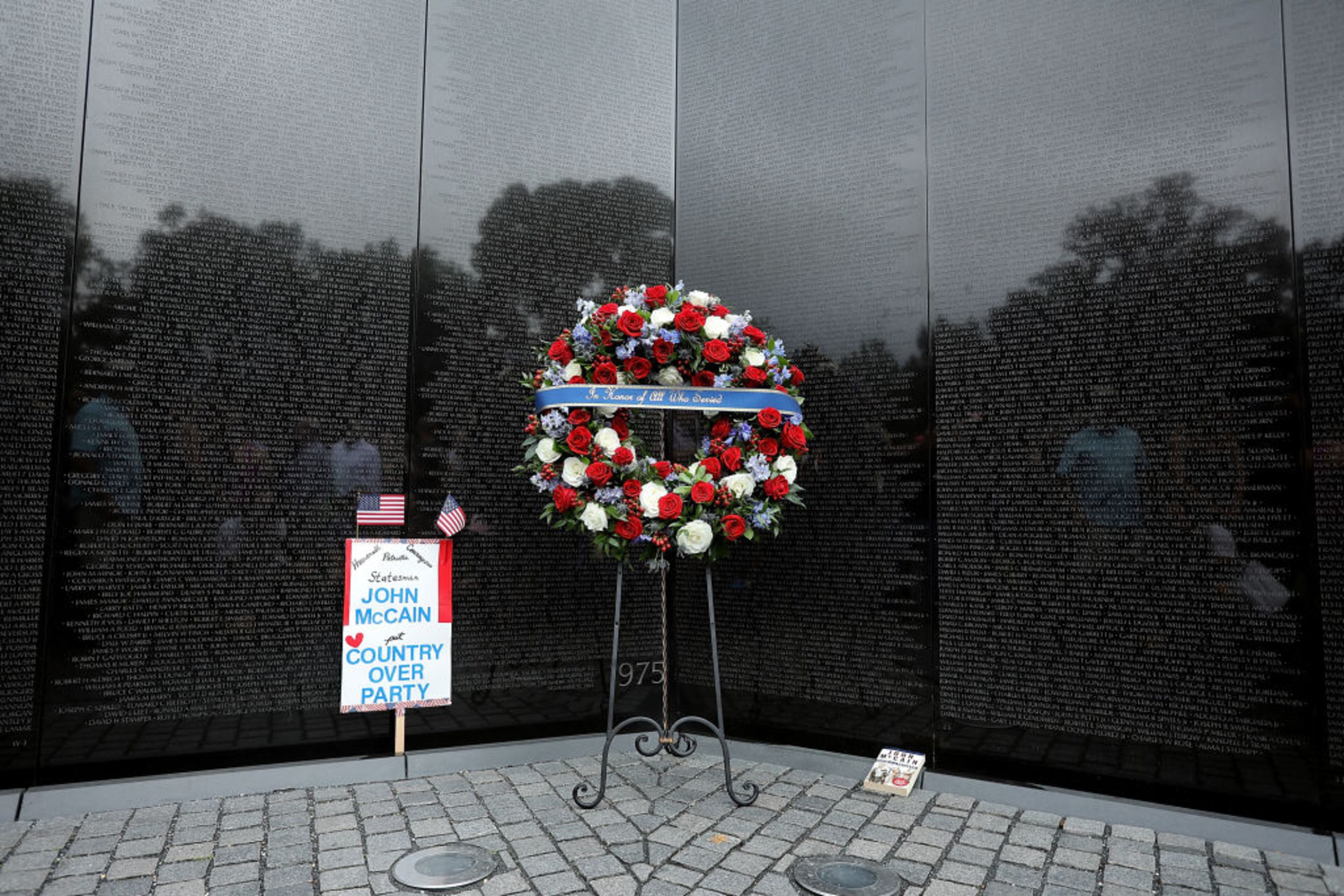 WASHINGTON, DC - SEPTEMBER 01: A wreath placed by the family of the late Sen. John McCain (R-AZ) stands at the apex of the Vietnam Veterans Memorial on the National Mall September 1, 2018 in Washington, DC. The late senator died August 25 at the age of 81 after a long battle with Glioblastoma, a form of brain cancer. Sen. McCain will be buried at his final resting place at the U.S. Naval Academy on Sunday. (Photo by Chip Somodevilla/Getty Images)