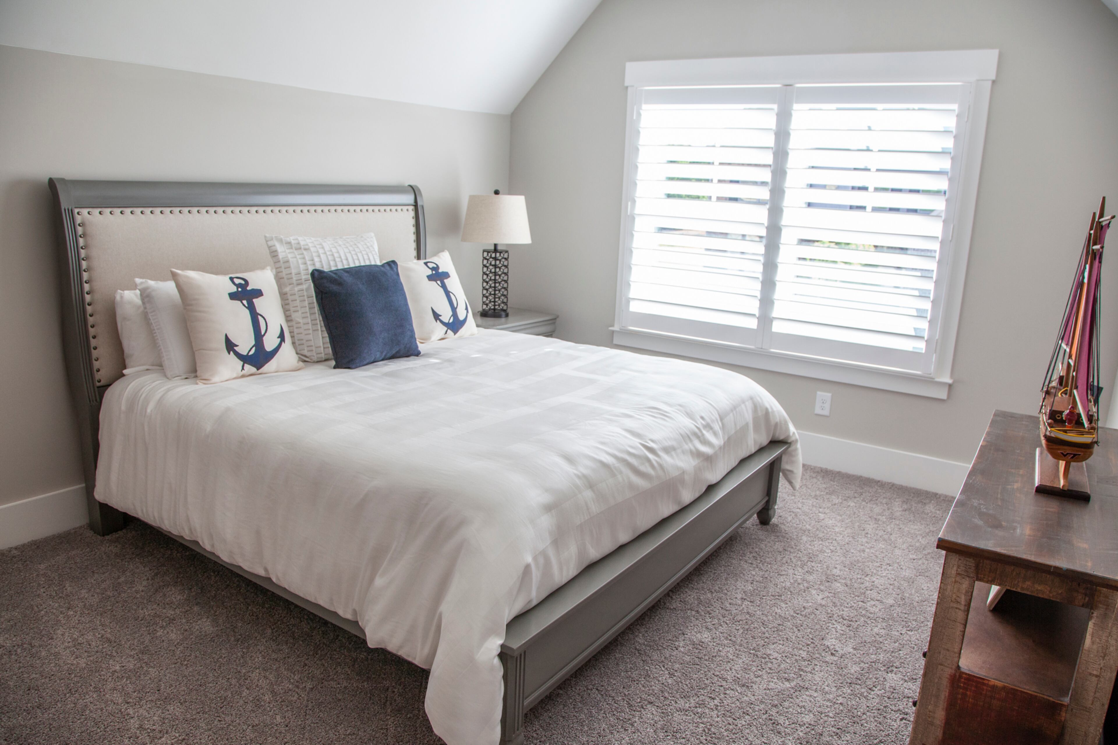 The bed in the guest room is from Woodstock Furniture & Mattress Outlet, accented with pillows from Pottery Barn.