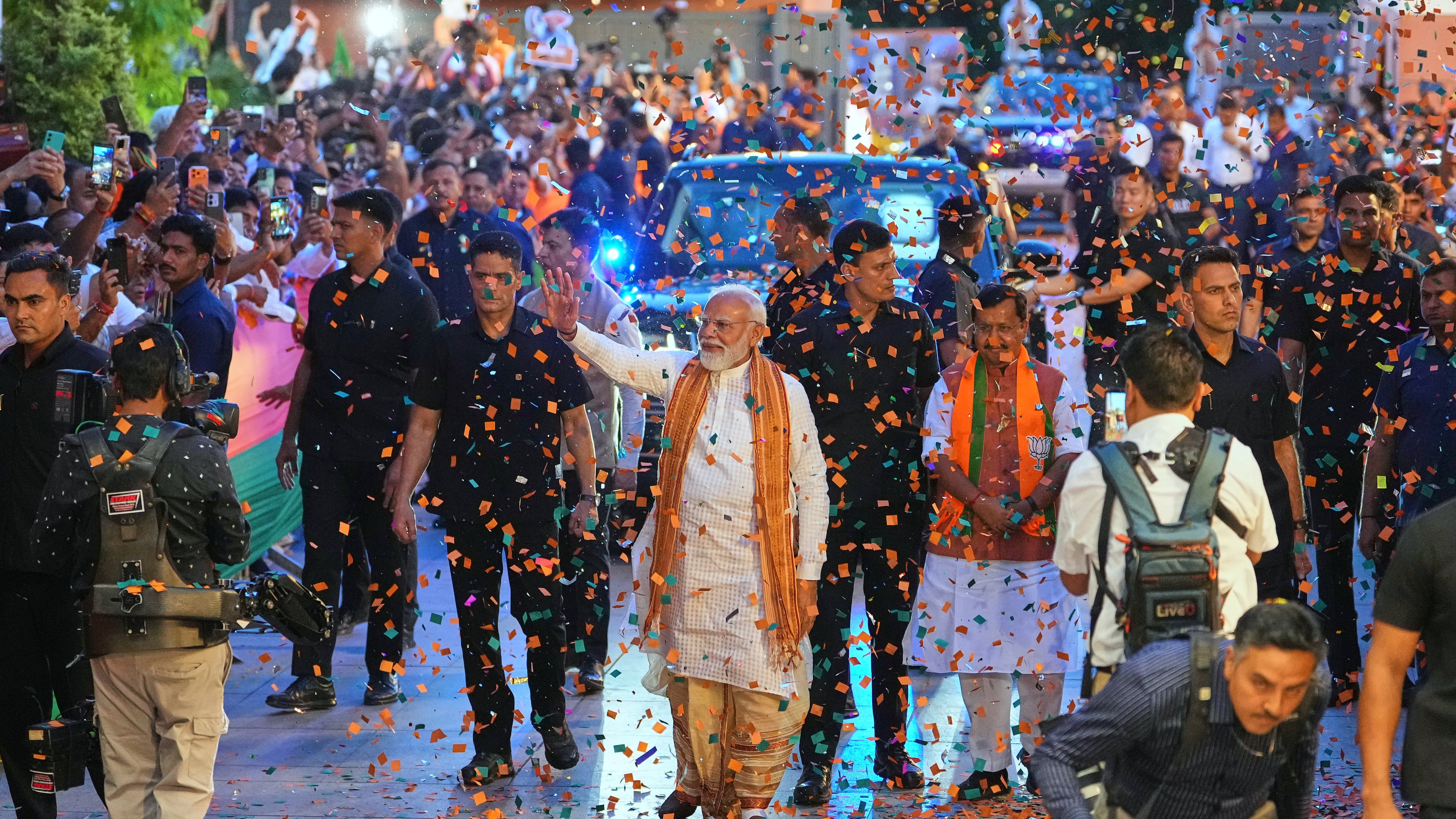 Confetti is sprayed as Indian Prime Minister Narendra Modi, center, waves to supporters upon his arrival at the Bharatiya Janata Party (BJP) headquarters to celebrate victory in the recently held state assembly elections in New Delhi, India, Monday, May 4, 2026. (AP Photo/Manish Swarup)