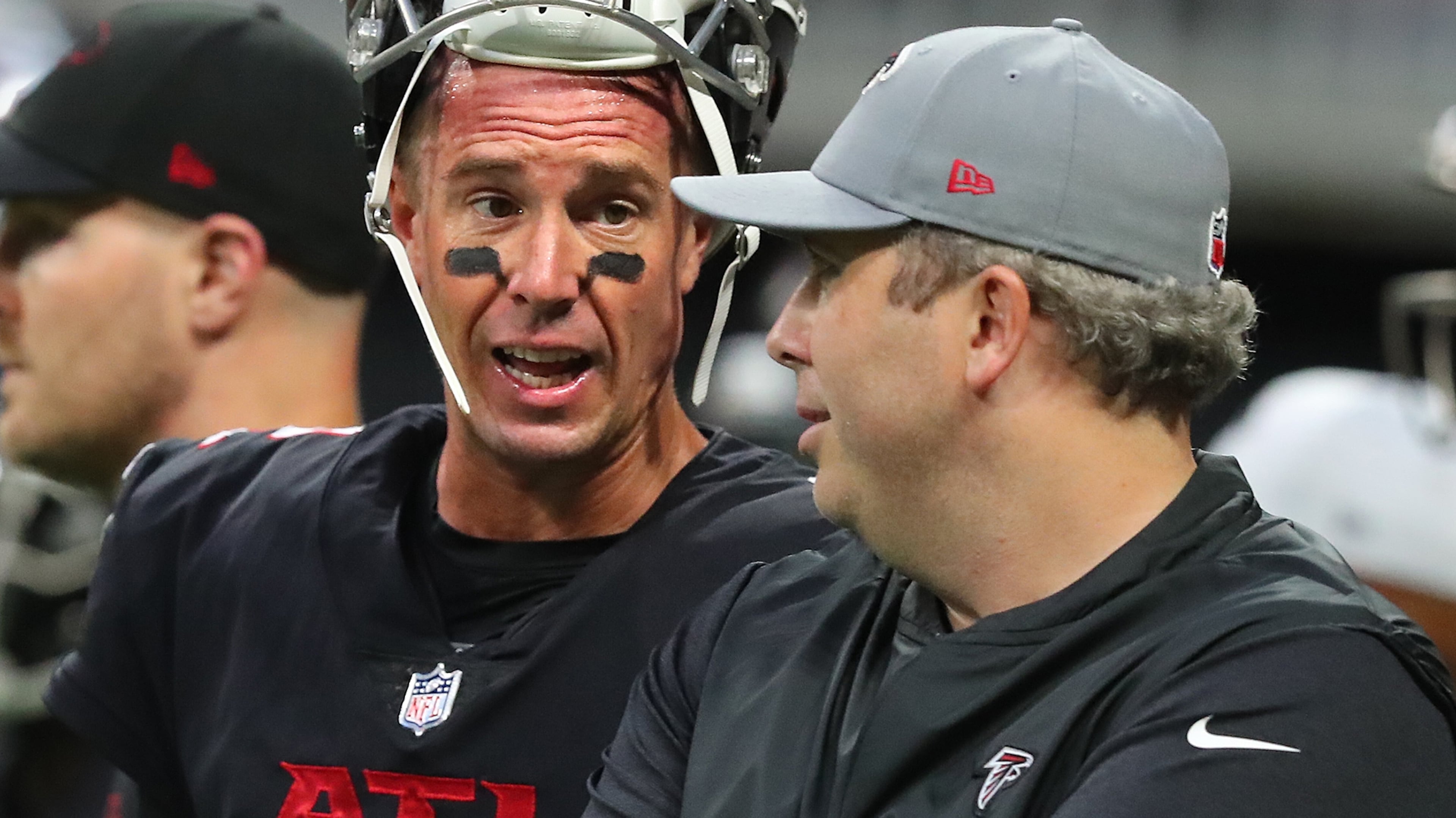 Falcons quarterback Matt Ryan confers with head coach Arthur Smith as they prepare to play the Cleveland Browns in the final exhibition game of the preseason Sunday, Aug. 29, 2021, at Mercedes-Benz Stadium in Atlanta. (Curtis Compton / Curtis.Compton@ajc.com)