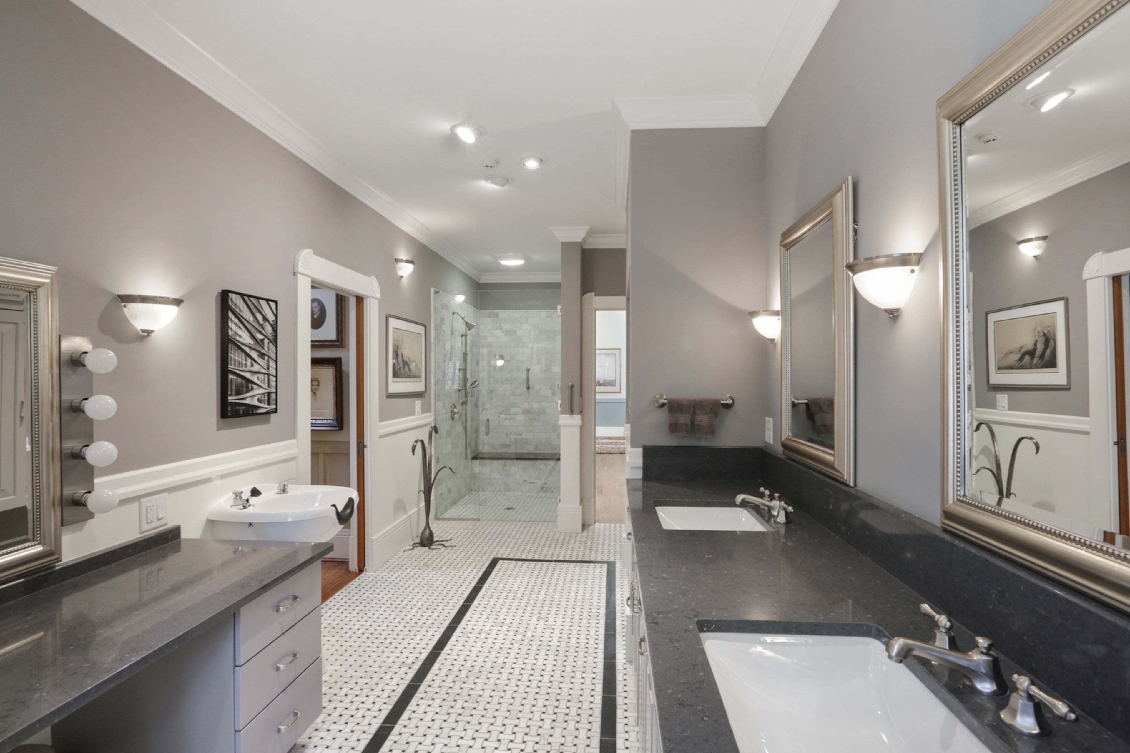 The owner's bath boasts double vanities, a walk-in shower, abundant storage, a walk-in tub as well as its own hair washing sink. The stand-alone jonquil is an inventive towel rack! Text by Jill Huitron