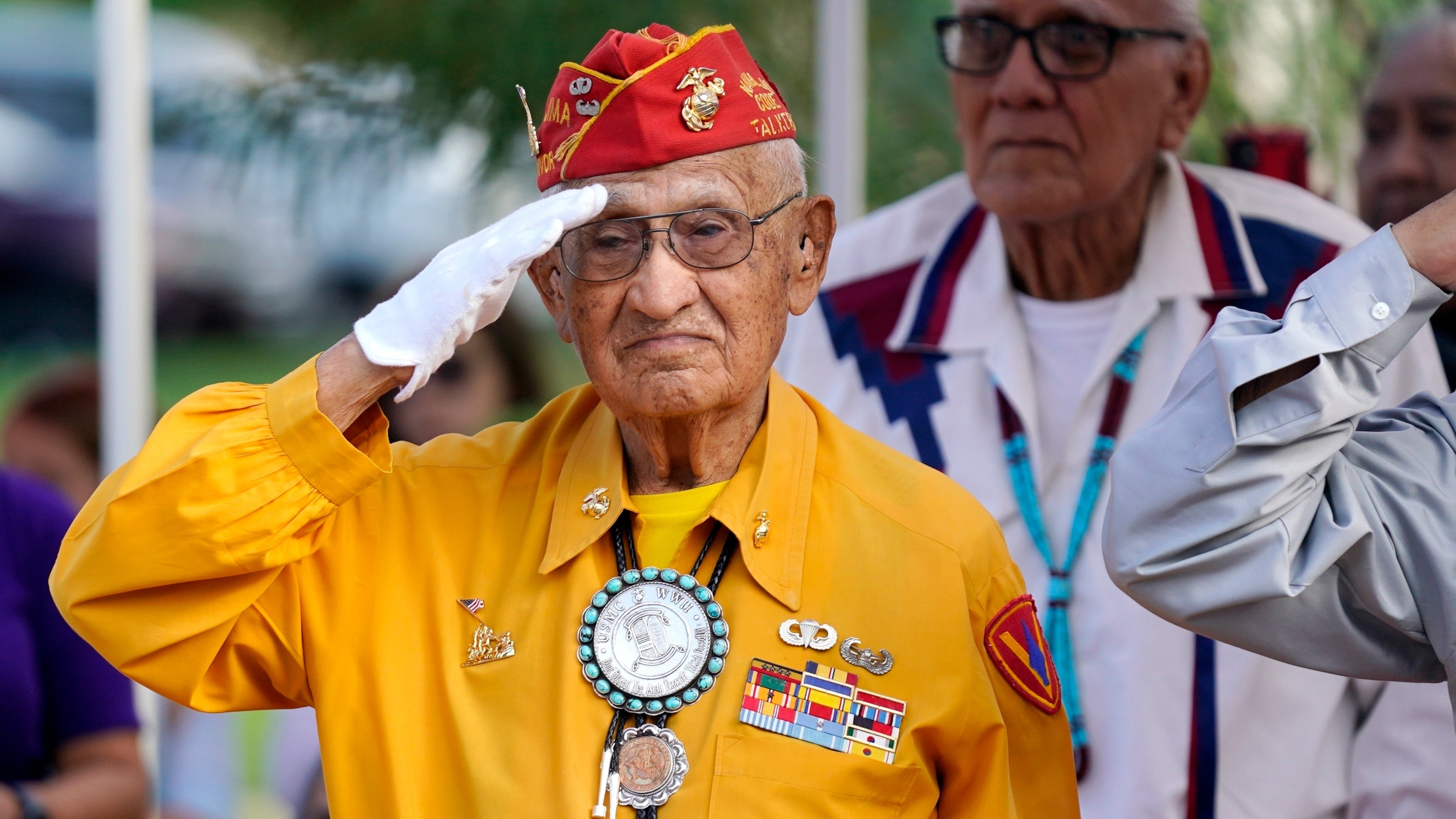 FILE - Navajo Code Talker Thomas Begay salutes during the national anthem at the Arizona State Navajo Code Talkers Day celebration, Aug. 14, 2022, in Phoenix. (AP Photo/Ross D. Franklin, File)